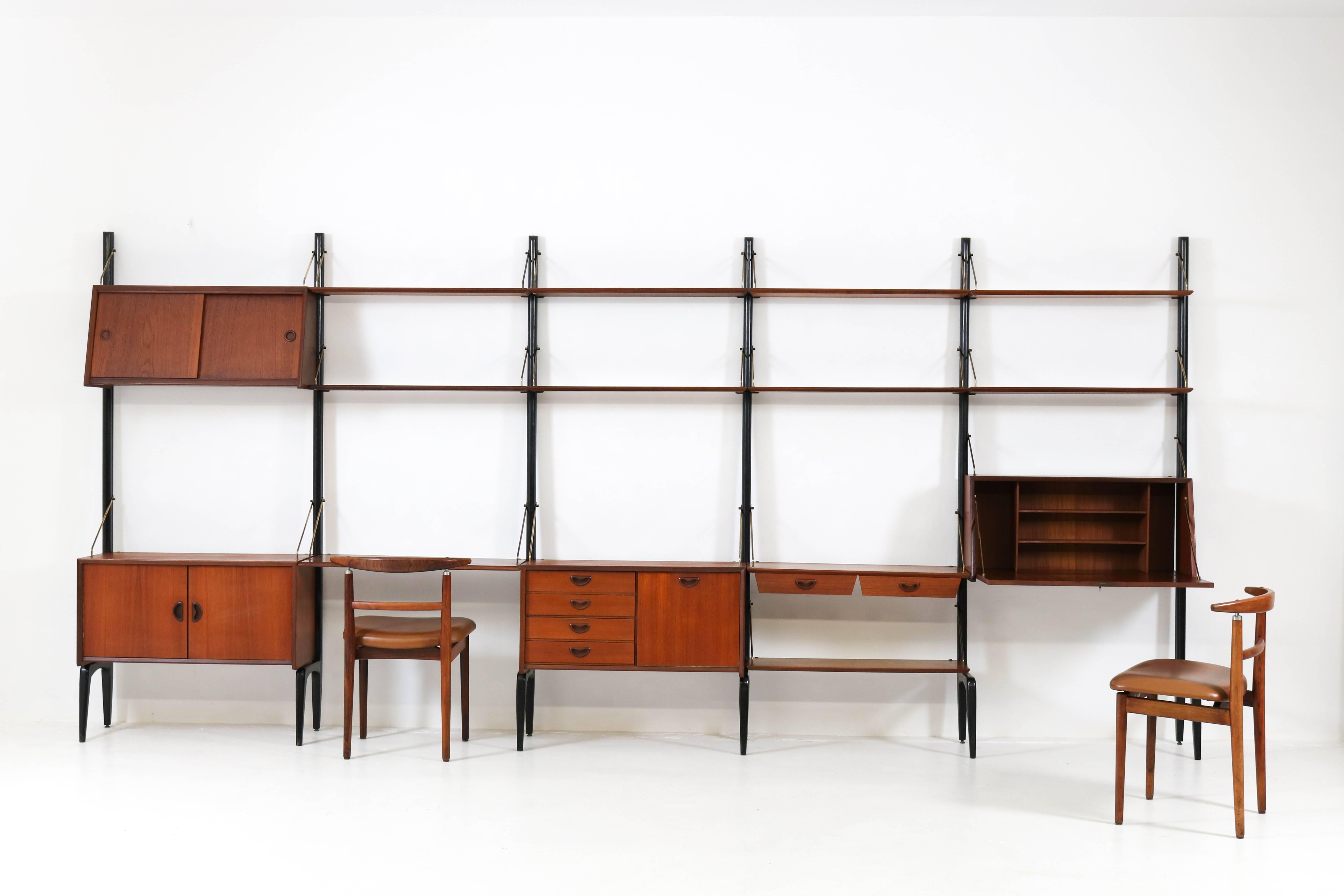 Extra large freestanding Mid-Century Modern wall unit by Louis Van Teeffelen for Webe, 1950s.
Original black lacquered wood, teak veneer and brass support rods with signs of wear and age.
This shelving system comprises:
Six original black