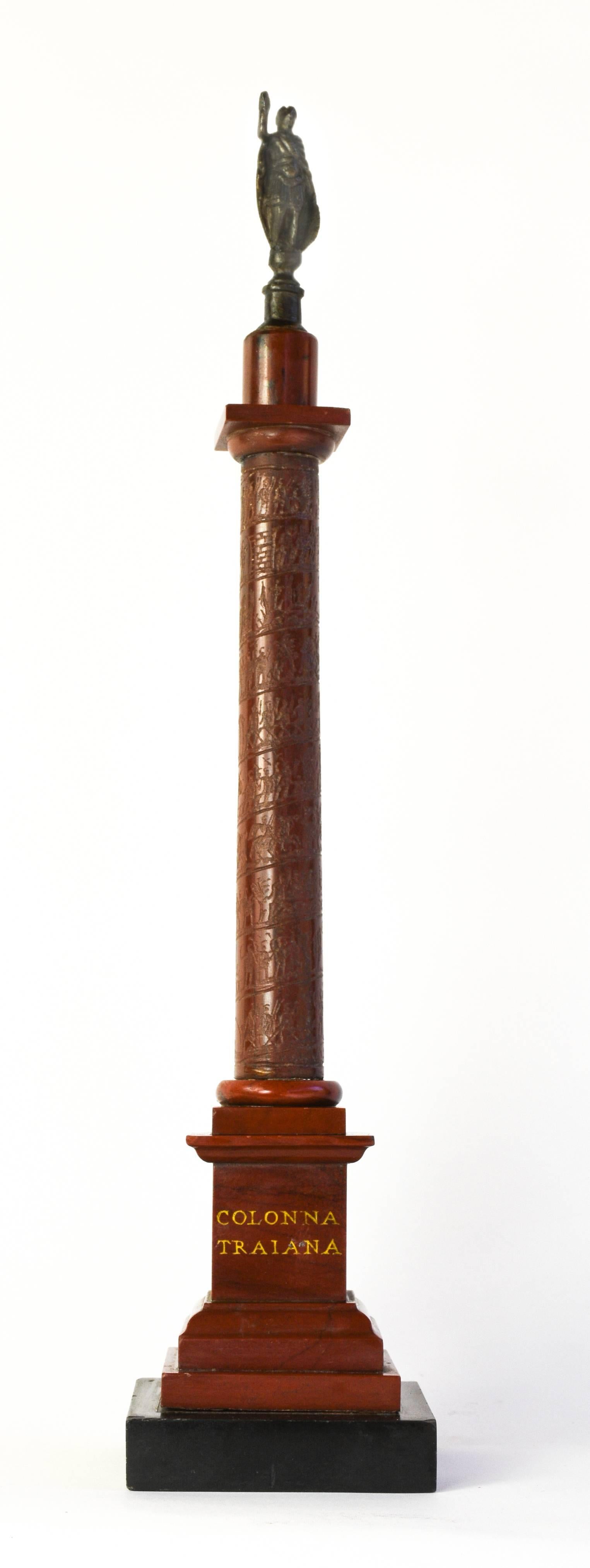 Early 19th century grand tour marble architectural model of Roman column.
Rosso and nero antico marble, with bronze figure.
Rome, circa 1820-1830, Measures: 13” H.

The triumphal column of Trajan, erected in Rome in 113 AD, has long been the