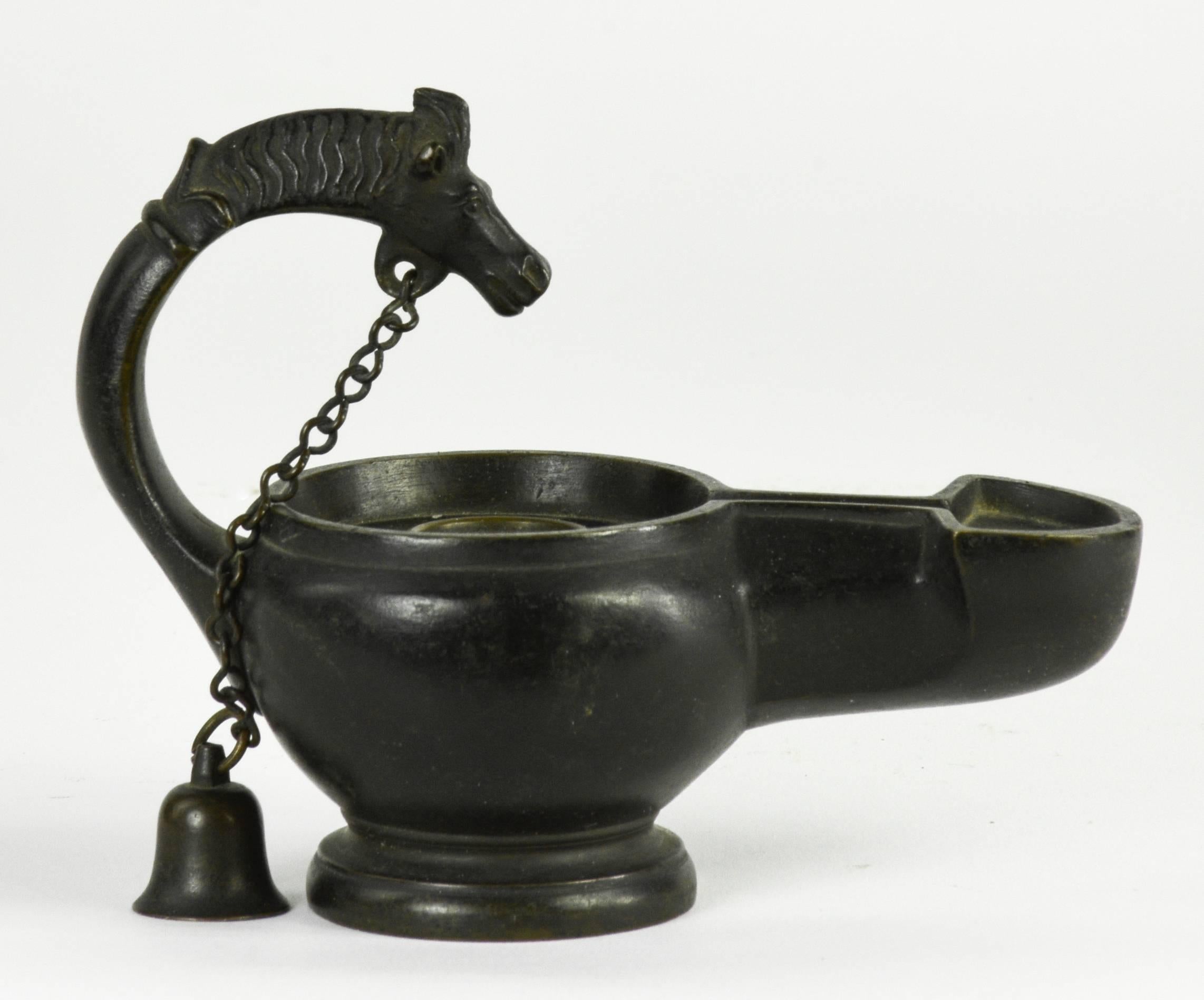 This set of three decorative, Roman bronze grand tour pieces, all copies of antique designs, consists of a handsome group of highly detailed, heavy bronze objects, with a very similar dark patina. 

The lamp, designed with a curving neck that