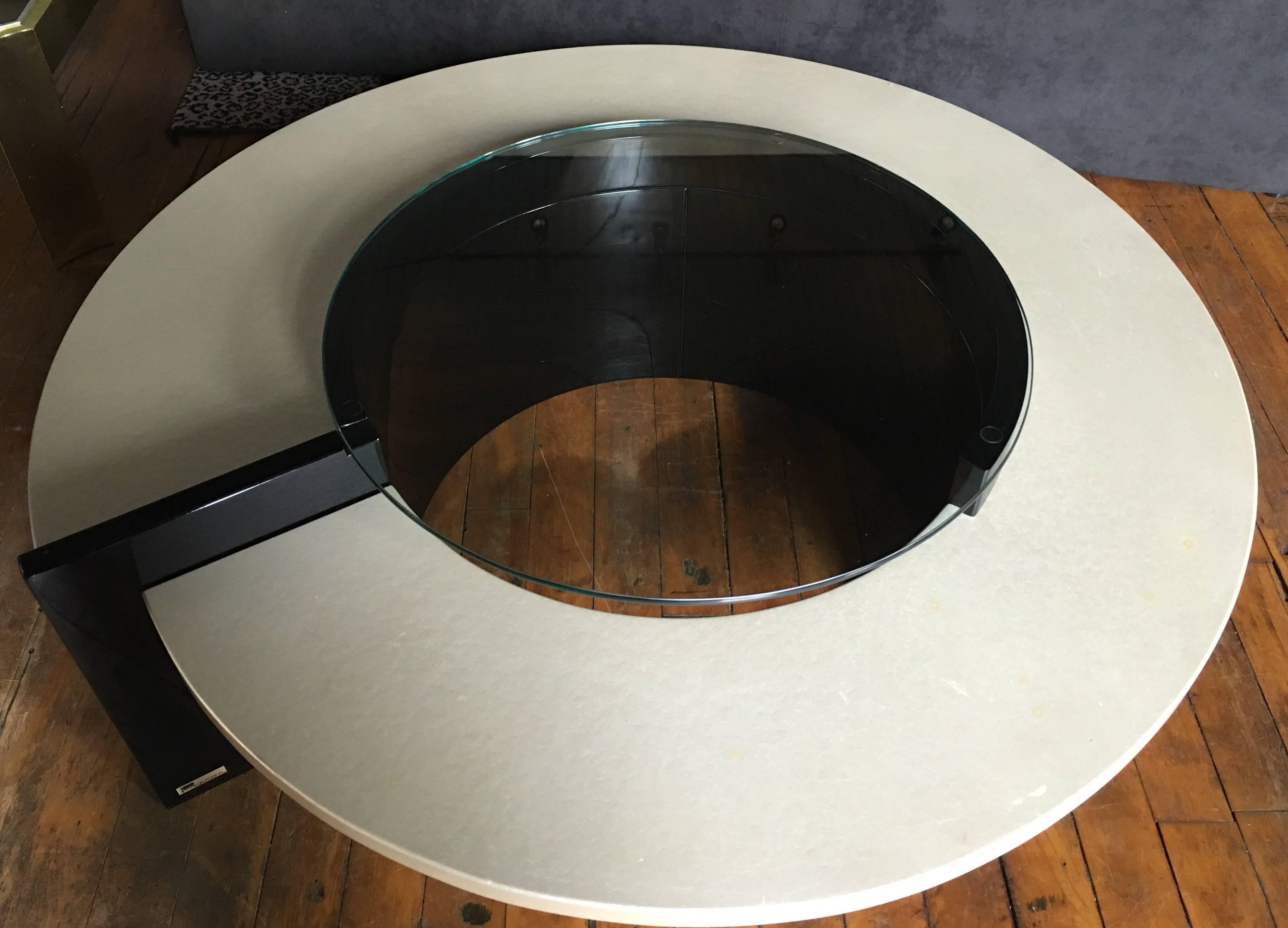 Sculptural abstract form cocktail table by Roger Rougier. Pearlized wood and black lacquer base with round clear glass top. Original metal Rougier label.