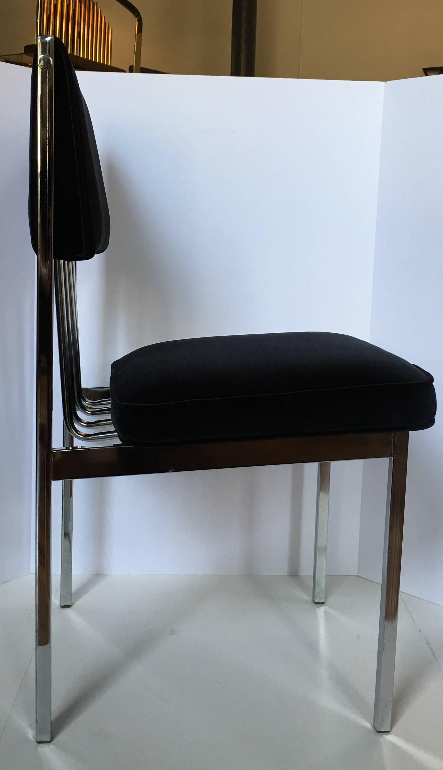 Beautiful set of four Mid-Century Modern chrome frame dining chairs featuring a sculptural tubular back design.  Newly upholstered in Italian black velvet fabric with new seat and back cushion inserts/foam.  In the style of Milo Baughman.