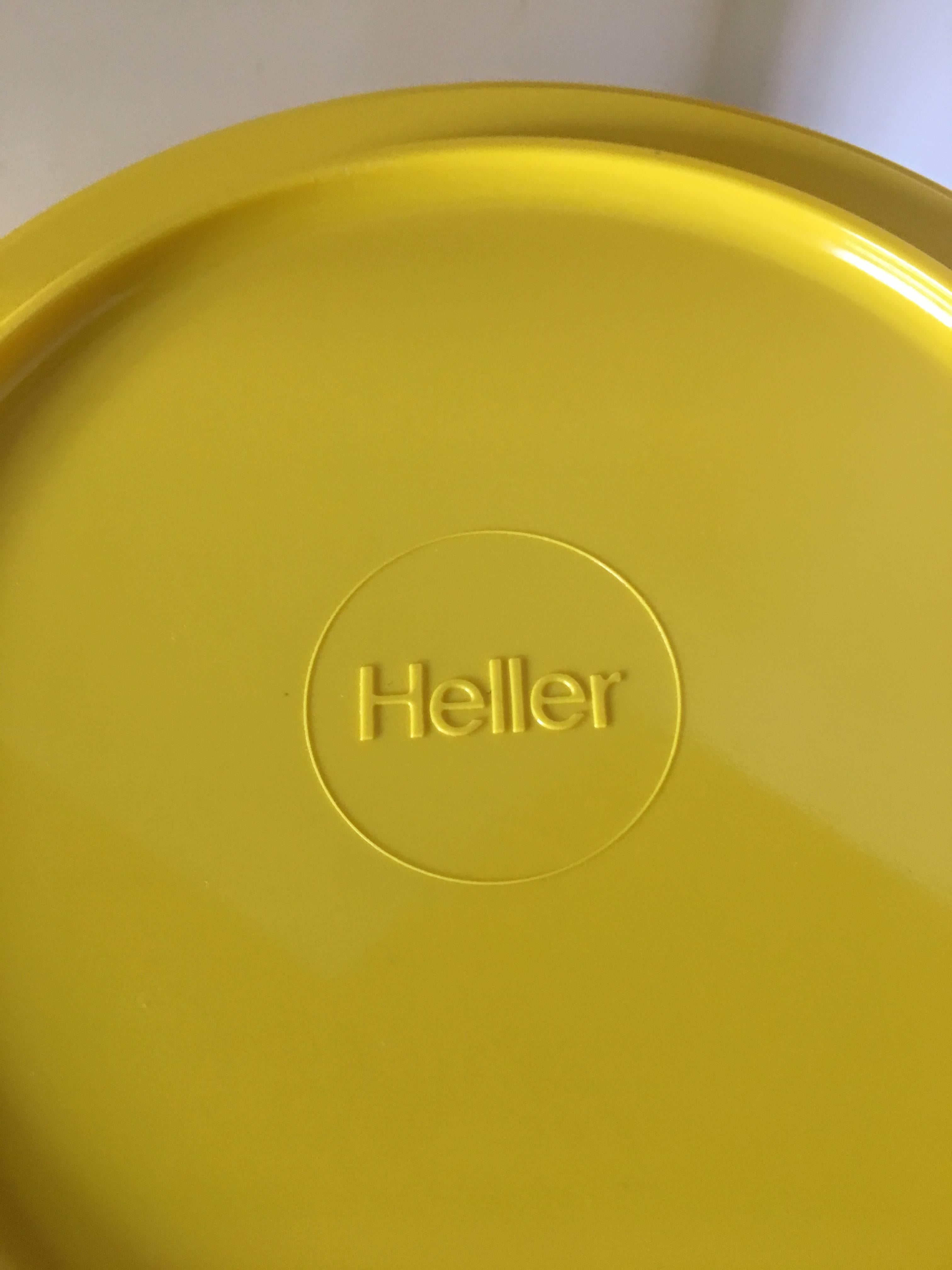 42-piece collection of vibrant yellow melamine dinnerware designed by Massimo Vignelli for Heller. This compact, stackable design is in the permanent collection at the Museum of Modern Art and the Metropolitan Museum. Some pieces not marked or