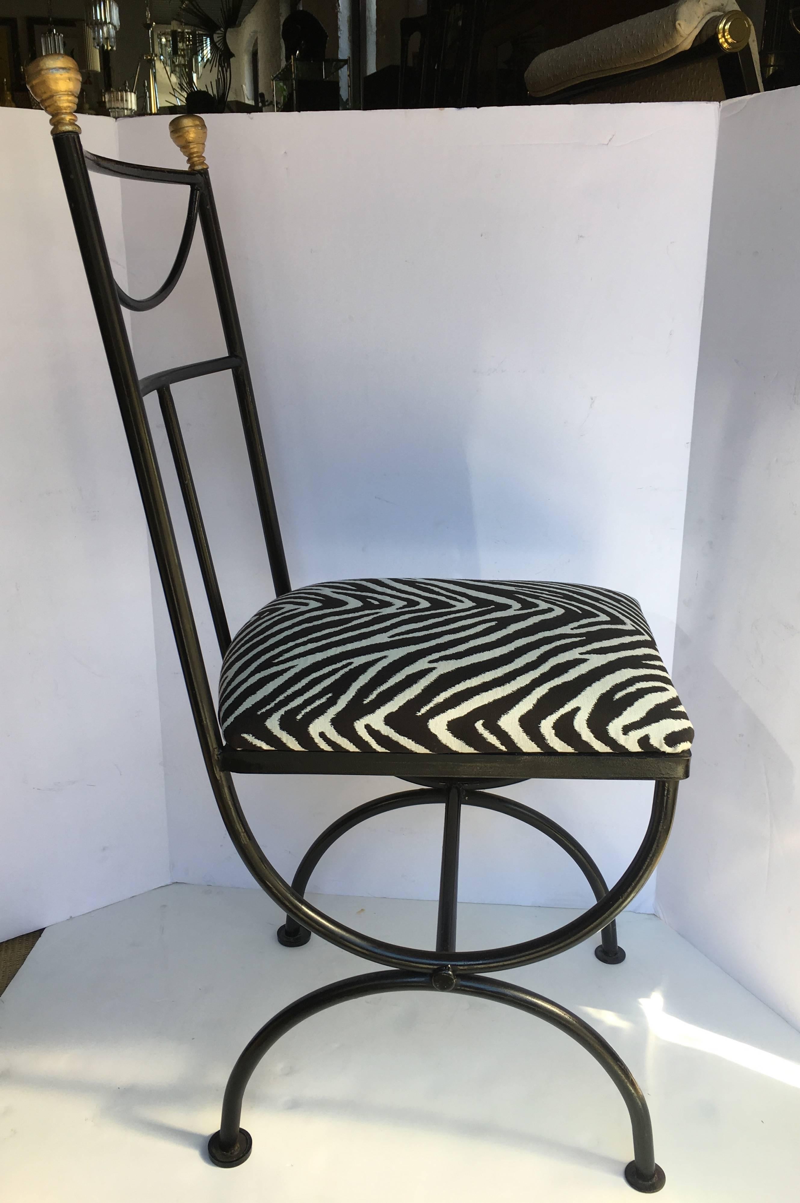 Mid-Century continental wrought iron "Savonarola" style accent or desk chair by Kessler. Black painted metal frame features a draped back design with gilt gold painted finials. New animal print upholstery.