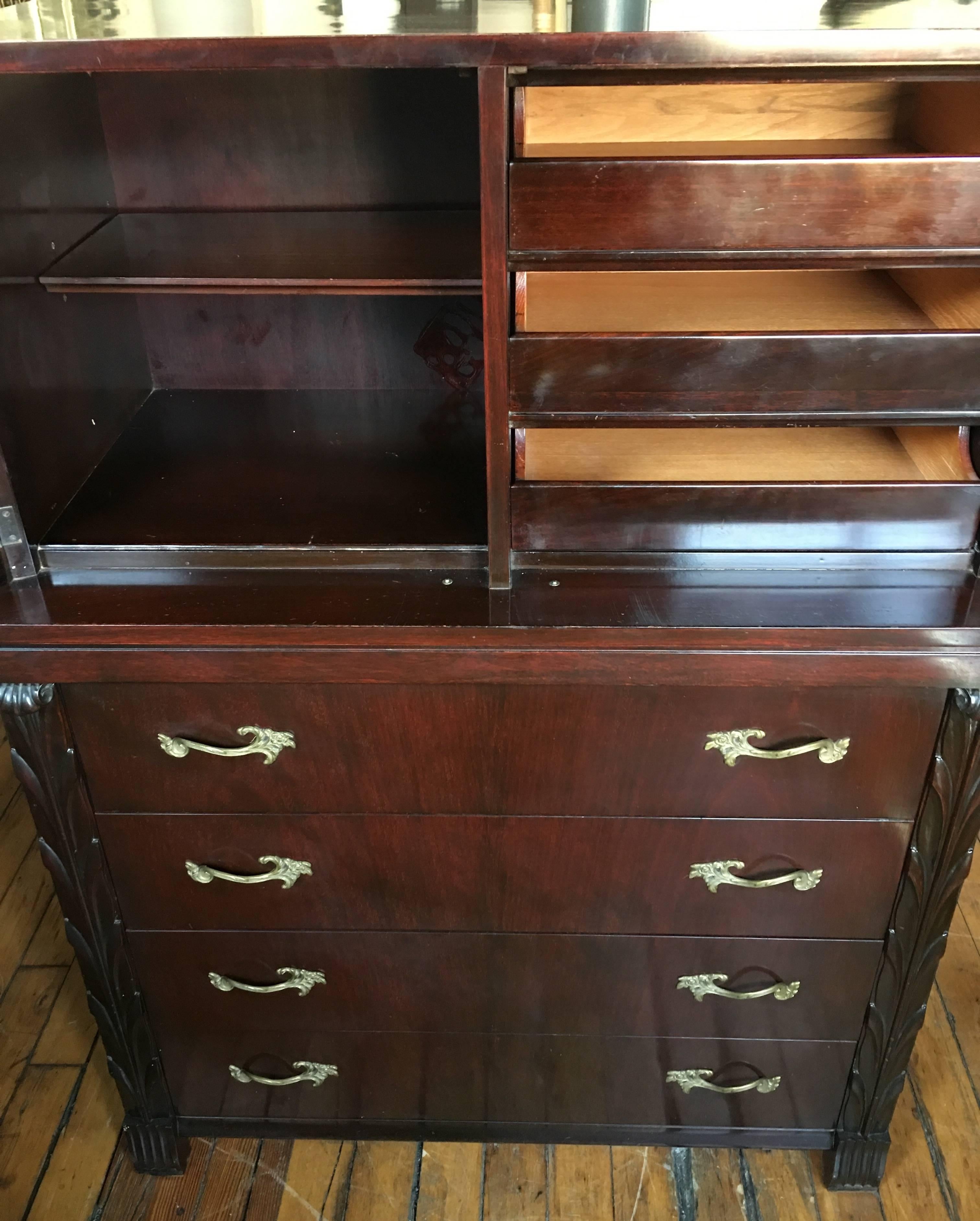 Fine rosewood chest of drawers by John Stuart for John Widdicomb Co. This bedroom storage cabinet features sculptural carved palm-like columns and original brass hardware. Original John Widdicomb paper label. Metal John Stuart label on inside of