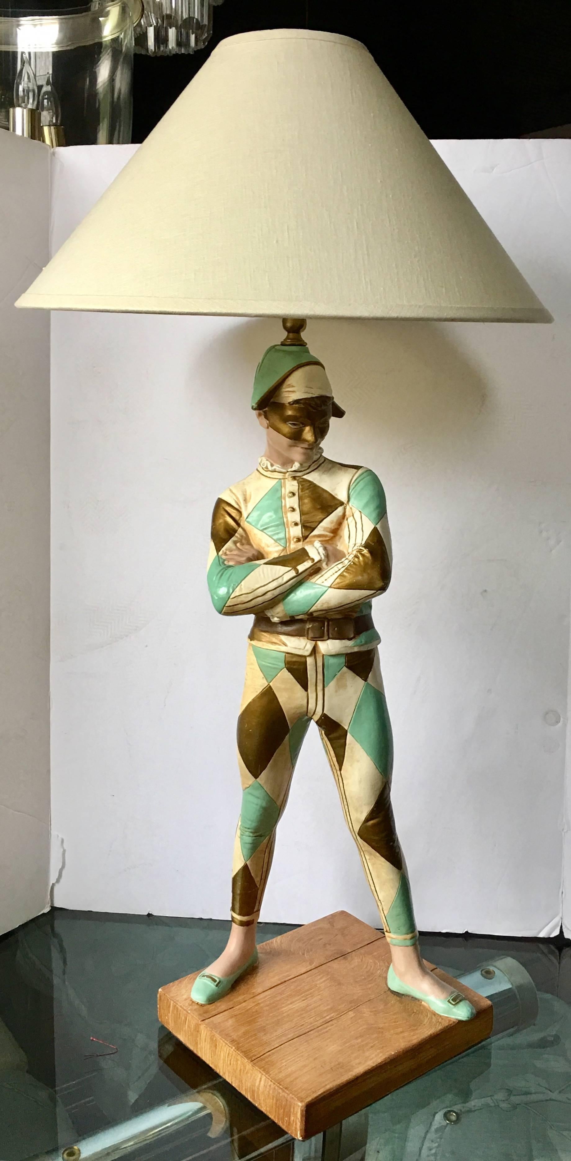 Mid-Century harlequin table lamp in the manner of Marbro lamp company. This large figural lamp is molded after the famous bronze sculpture "Arlequin" by Rene de St. Marceaux which is on display at Musee d'Orsay in Paris. The sculptural