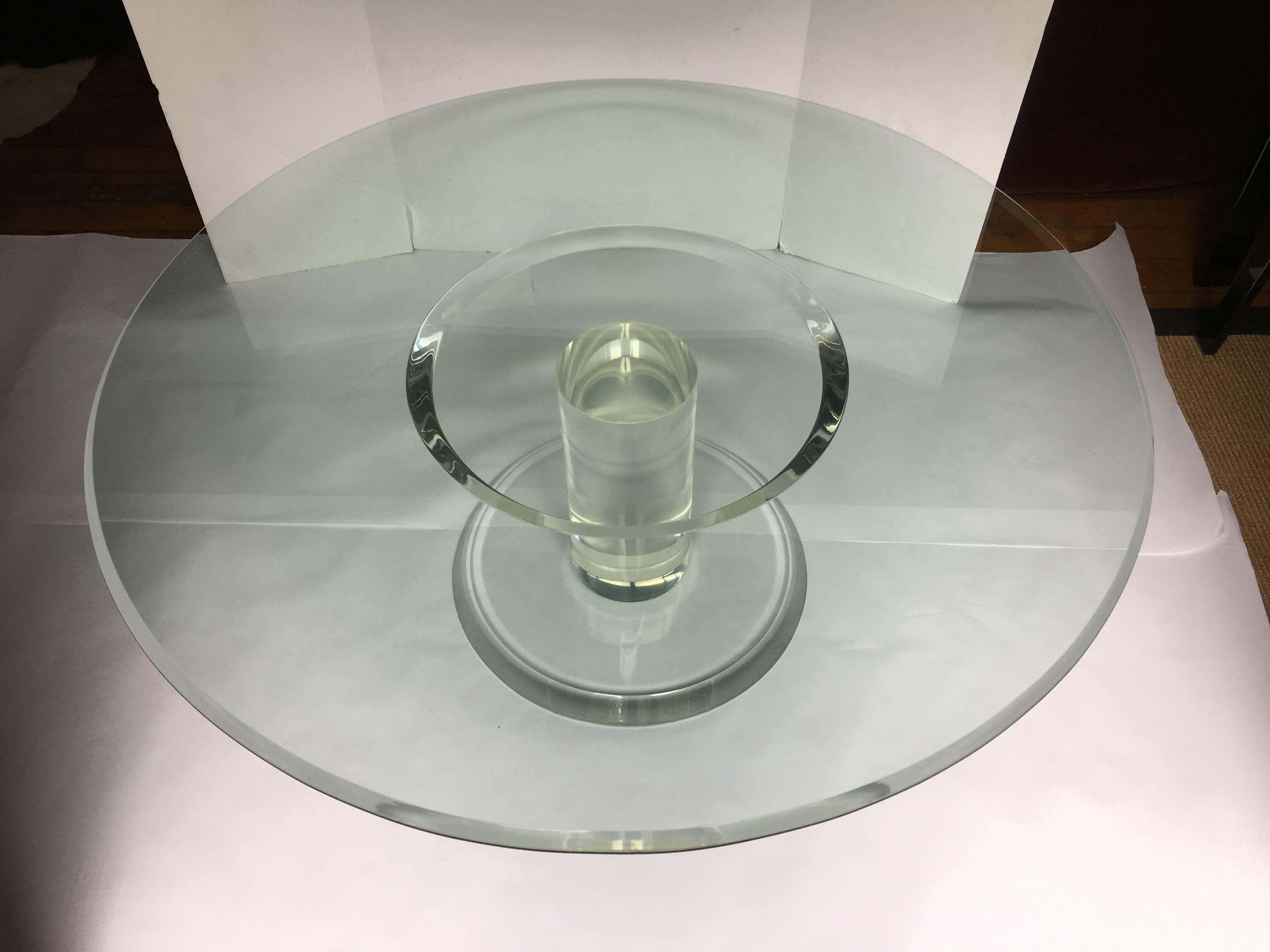 Large Mid-Century Modern heavy Lucite and glass pedestal coffee table in the style of Charles Hollis Jones. Thick Lucite centre column base supports a removable round 3/4 inch thick round bull nosed glass top.