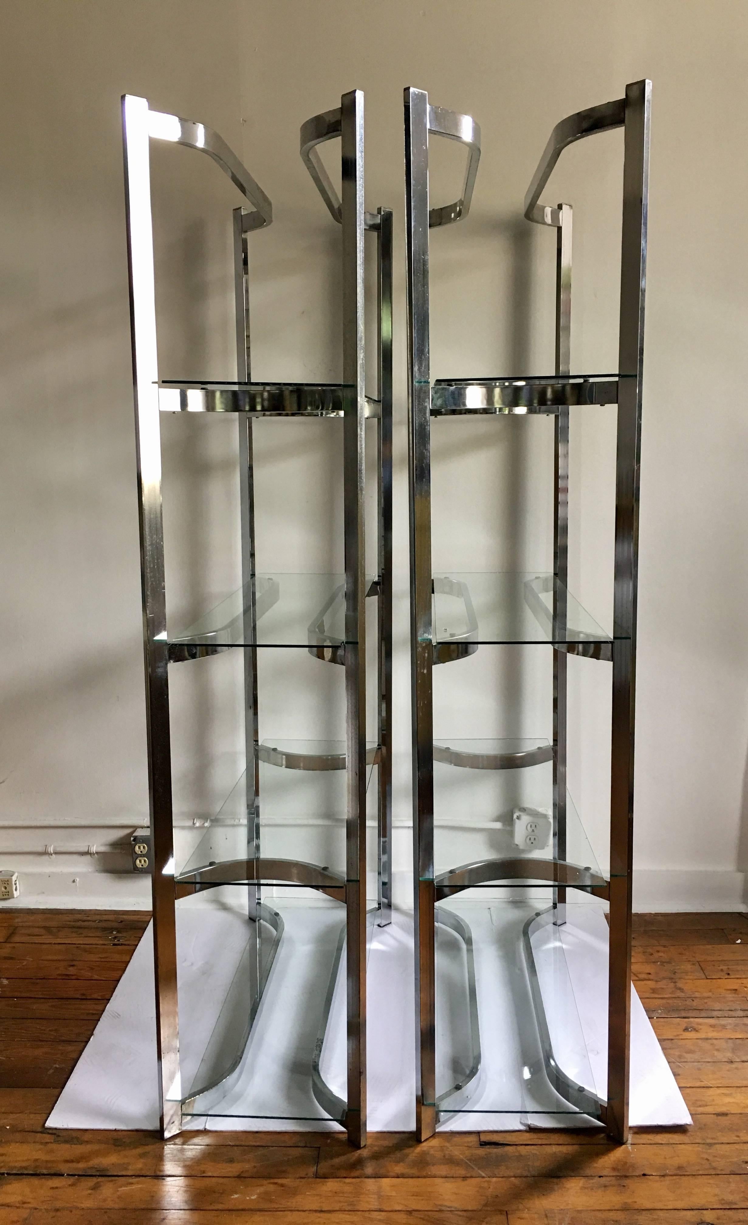 Pair of Mid-Century Modern chrome and glass étagères. These shelving/bookcases feature curved sculptural frames with removable clear glass shelves.
