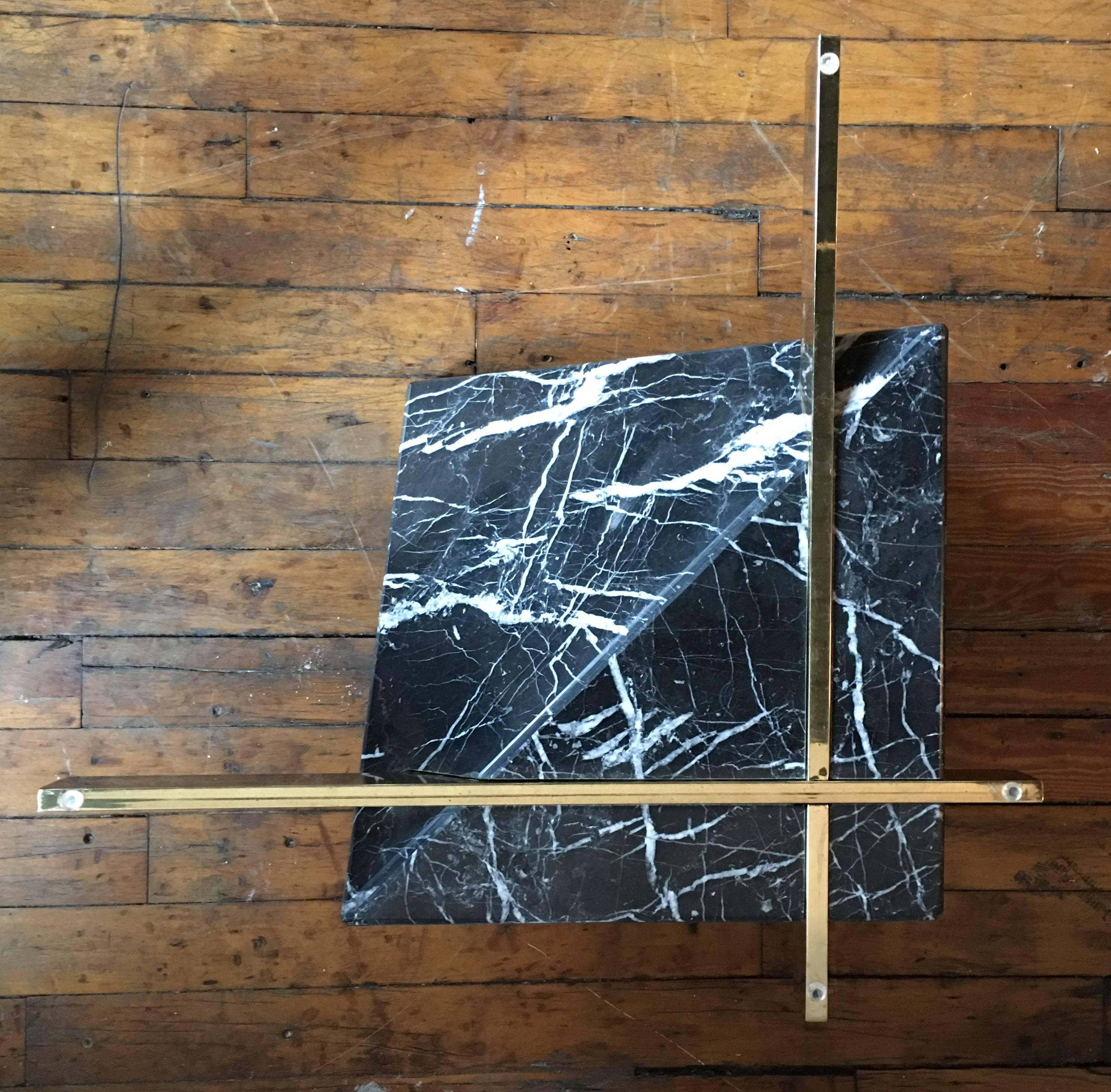 Mid-Century Modern Italian Marquina black and white marble cocktail table base attributed to Artedi.  Design features a cruciform polished brass plated support affixed to an angular geometric form marble base.  

Glass top not included.    
Original