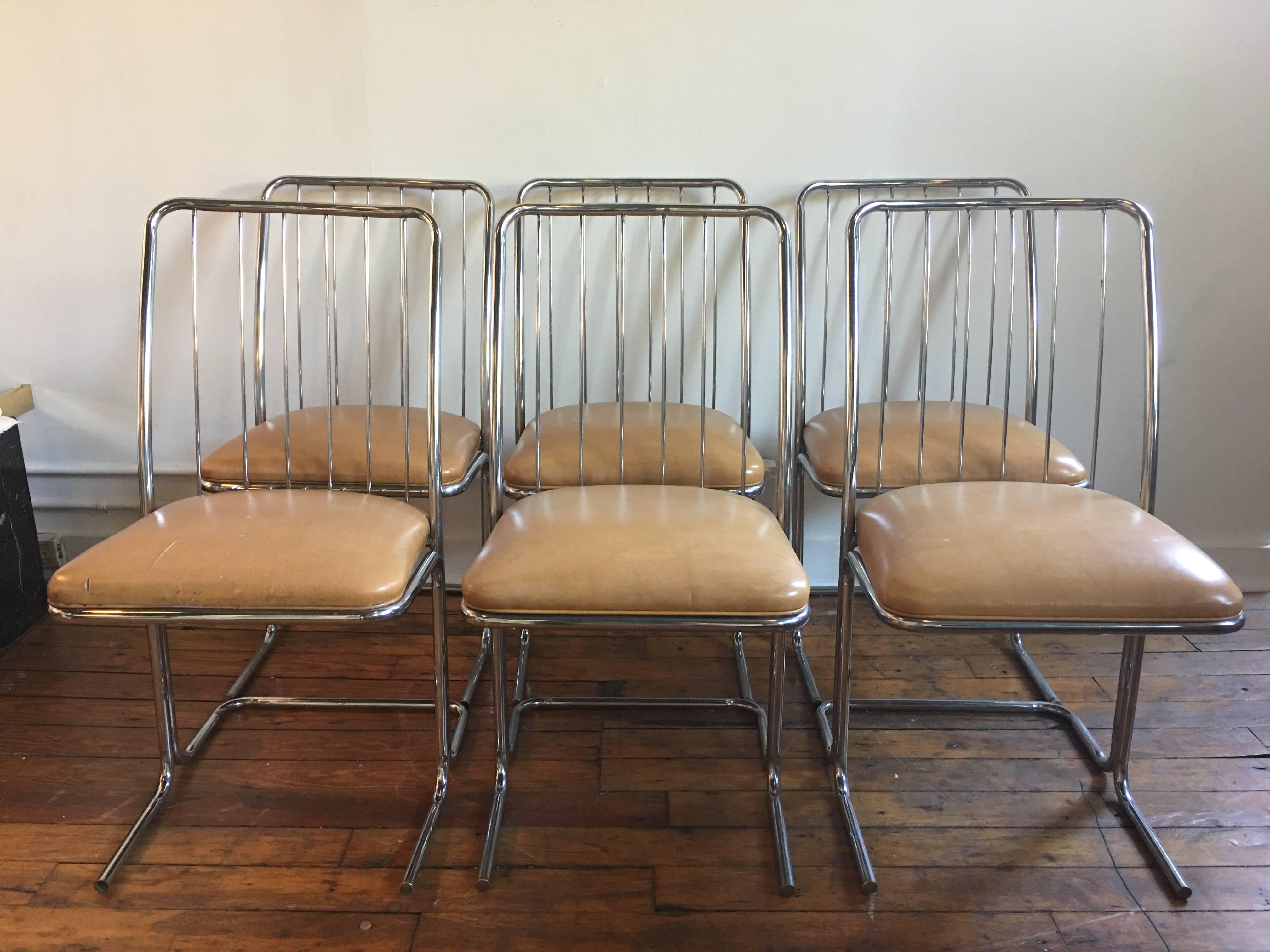 Set of six Mid-Century Modern chrome dining chairs featuring a cantilevered tubular metal frame and a wire back design. Manufactured by Daystrom Furniture. Original vinyl upholstery.