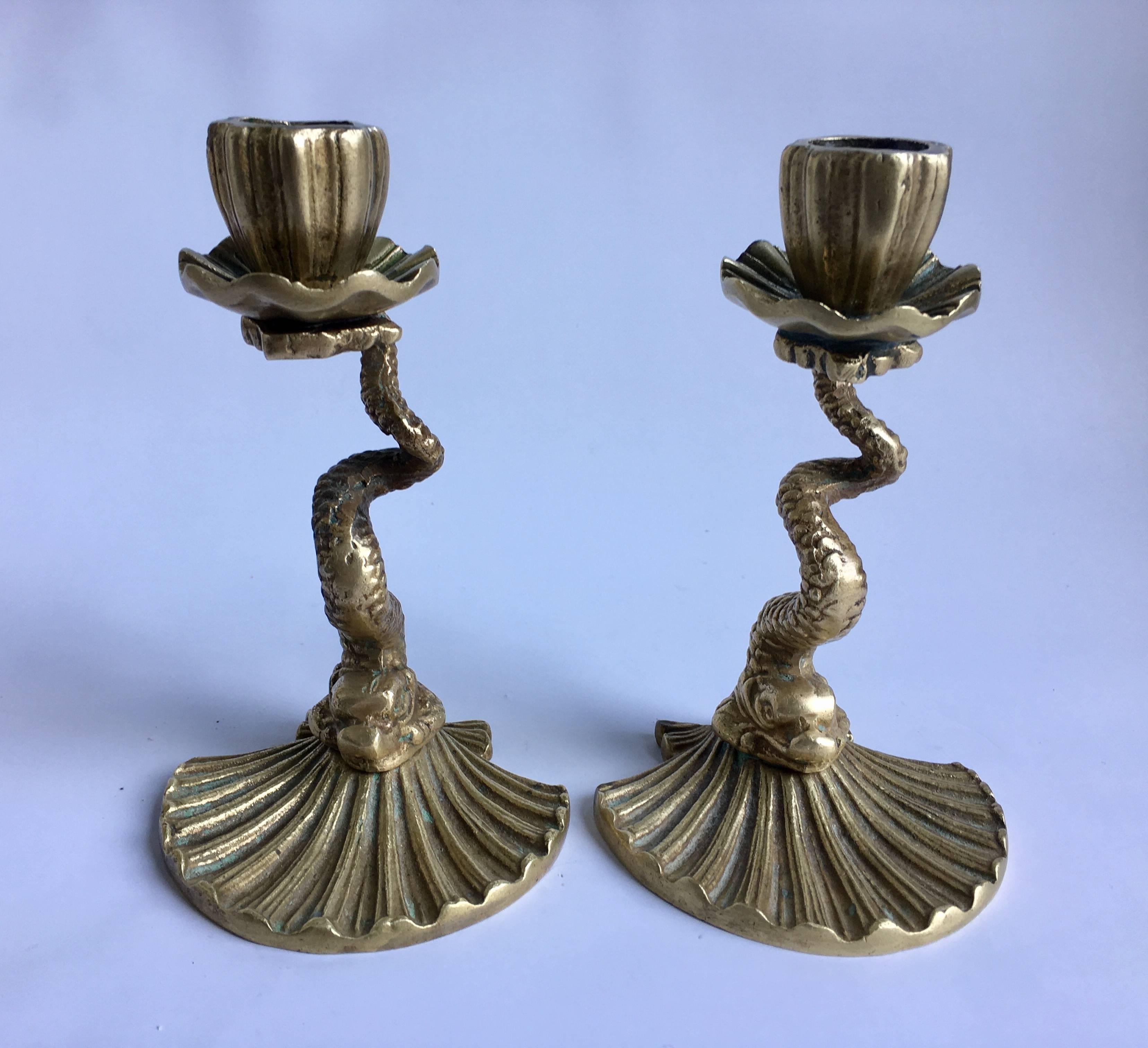 Mid-Century koi fish/serpent brass figurative candlesticks by Arthur Court. These Asian inspired sculptural curved candlesticks feature a dolphin-like creature mounted on a shell form base. Stamped and dated 1979 on bottom.