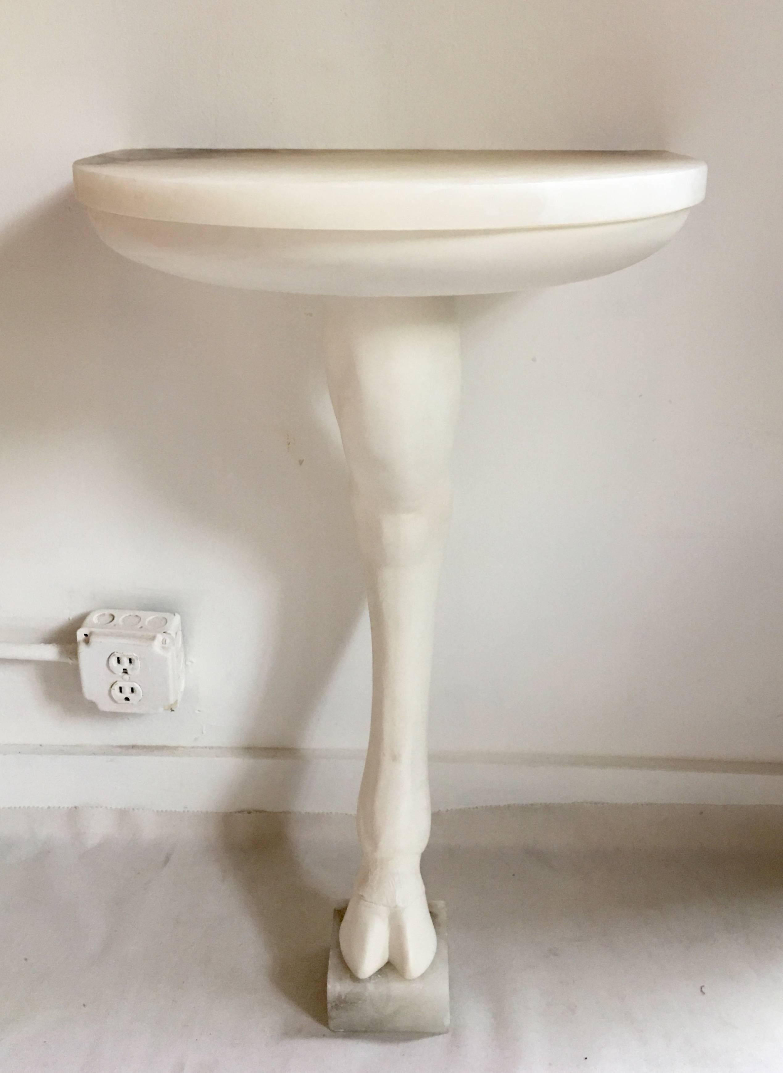 Sculptural angora goat leg animal console table by Barry Dixon. Figural resin base features plaster white finish with grey/white toned marble top and base.  In the style of John Dickinson.  