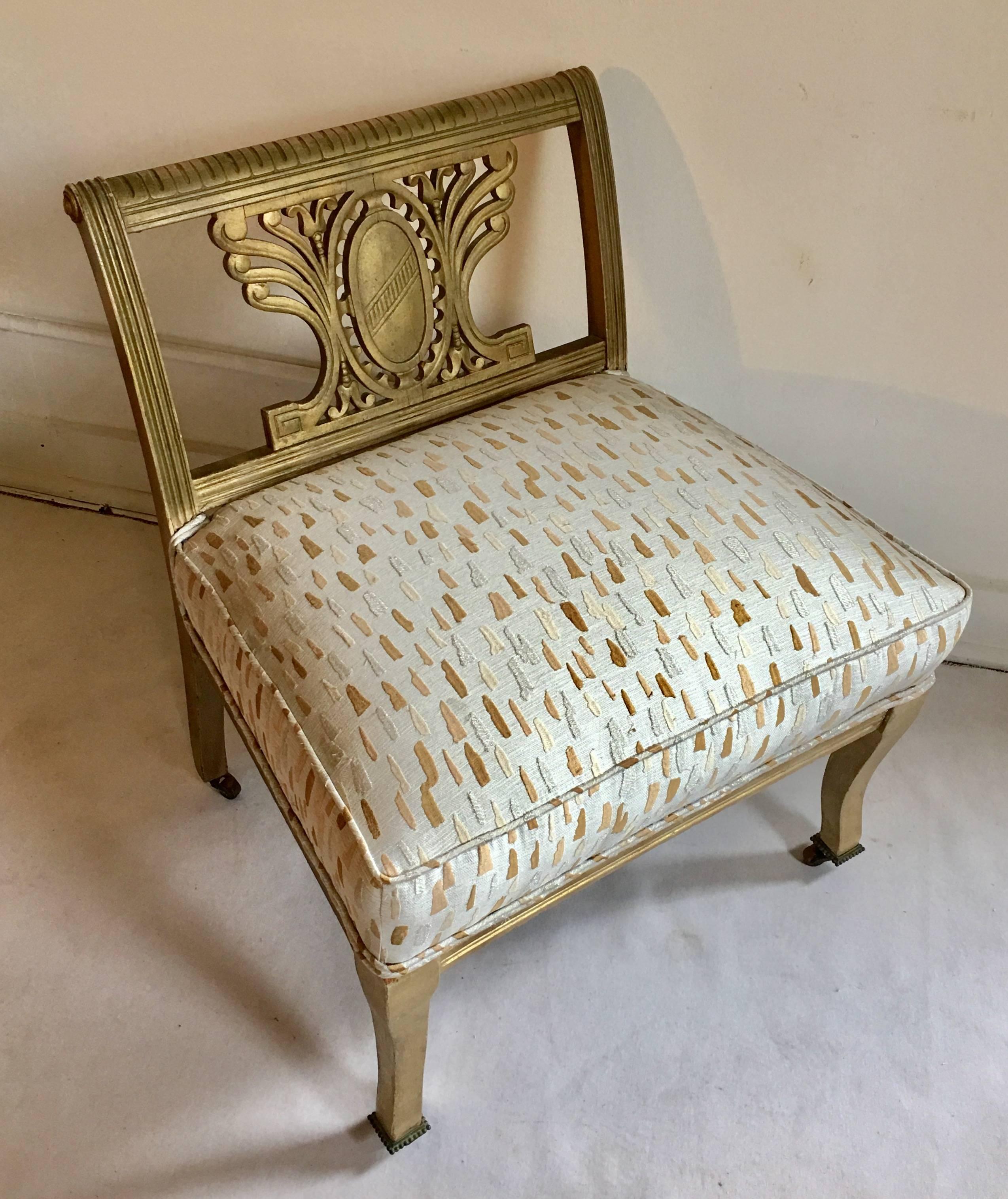 Mid-Century carved wood vanity chair or bench newly upholstered in Laura Kirar/Highland Court geode metallic thread fabric. Chair frame features a carved crest or shield back, scrolled details with Greek key motif and original aged gilt painted
