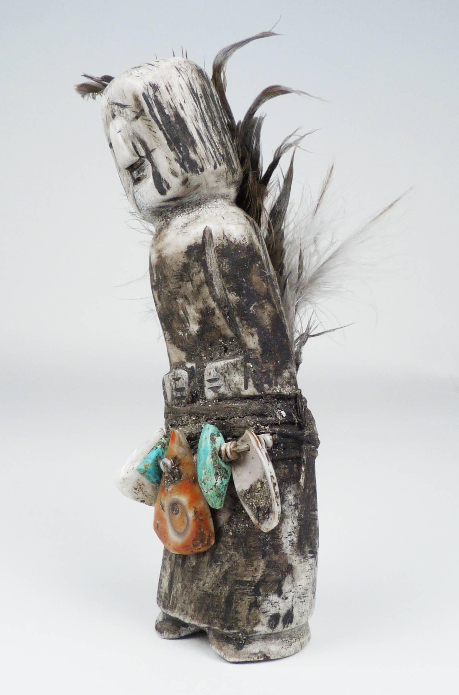 This fetish was carved by Teddy Weahkee (1890-1965), an accomplished painter, silversmith, inlay artist and carver at Zuni Pueblo. Representing a humanoid figure, this fetish is carved from deer antler, decorated with turquoise and shell beads, and