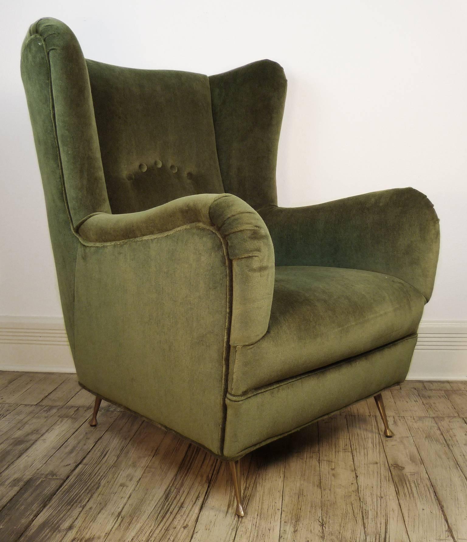 A beautiful pair of oversized vintage wingback chairs, newly reupholstered in rich green mohair, with completely original brass legs. 