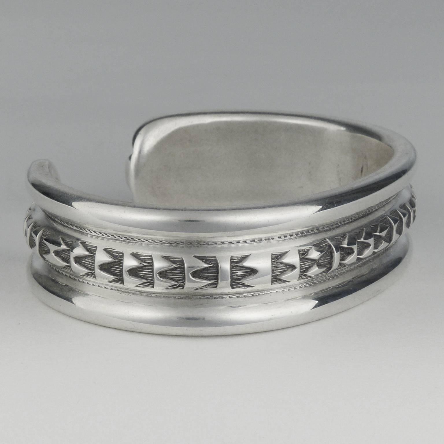 A beautiful piece of jewelry by the one of the most widely sought-after Navajo silversmiths working today. Exquisitely wrought from heavy gauge sterling silver, this bracelet is hand formed and hand stamped. Signed on the inside with his signature