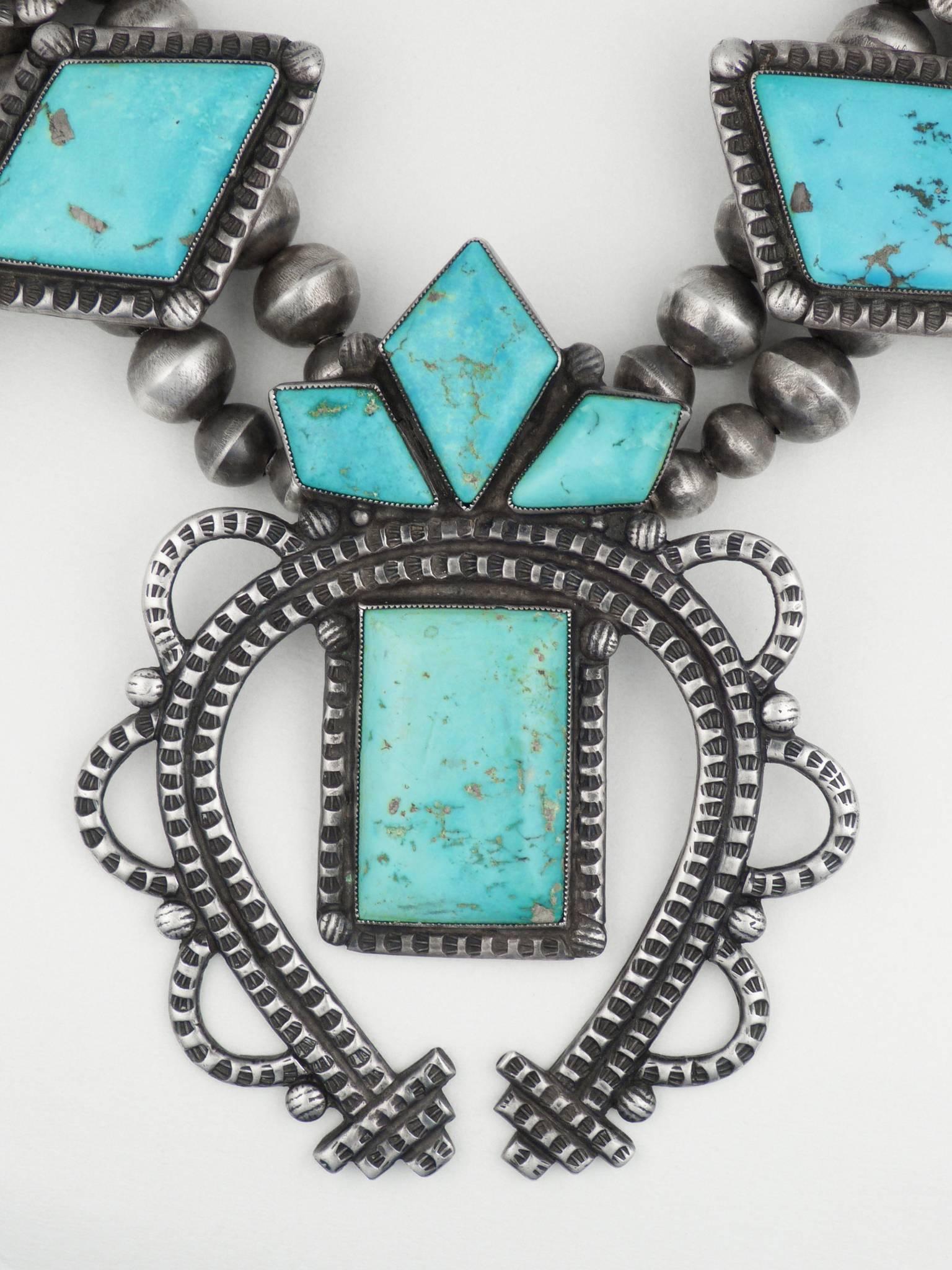 A beautiful and unusual vintage Zuni squash blossom necklace, made of sterling silver and natural American turquoise. 24 3/4 Long.
