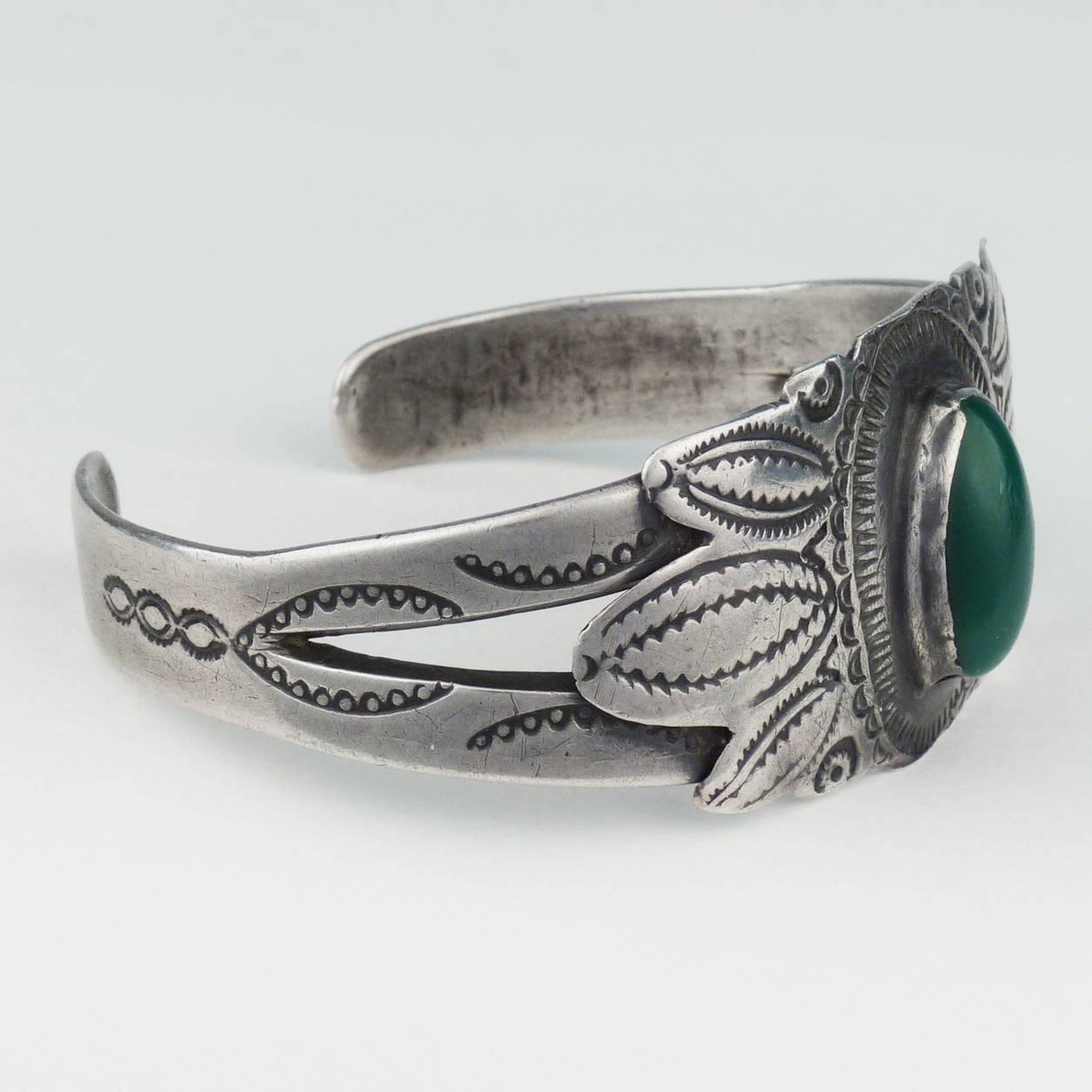 An early example of Navajo silverwork. Incredible patina and wear, hand wrought silver, and a handmade bezel surrounding the Cerrillos turquoise cabochon. 5.63" cuff, 1" opening. 