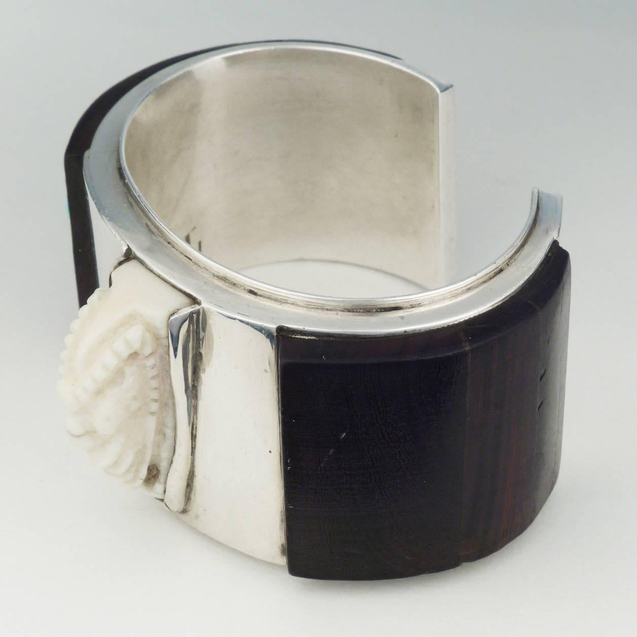 Eveli Sabatie, apprentice, partner and muse of Charles Loloma made this cuff in 1970 while living in Hotevilla, on the Hopi reservation. Hand fabricated sterling silver cuff, painstakingly inlaid with ironwood slabs, and set with a hand carved  ram