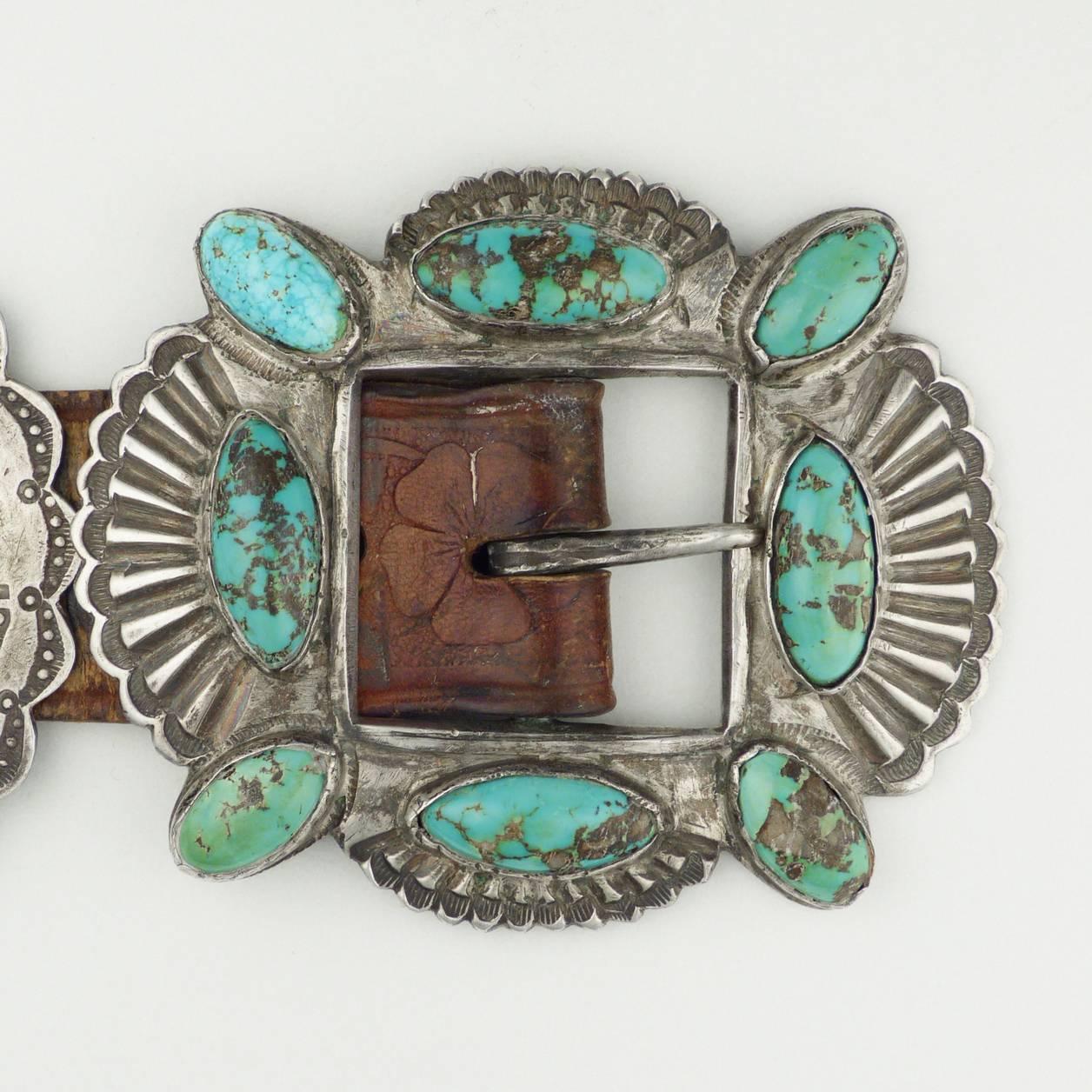 This is a vintage Navajo Concho belt dating to the early 1940s. It is set with 21 bezels of natural American turquoise. It measures 42.5