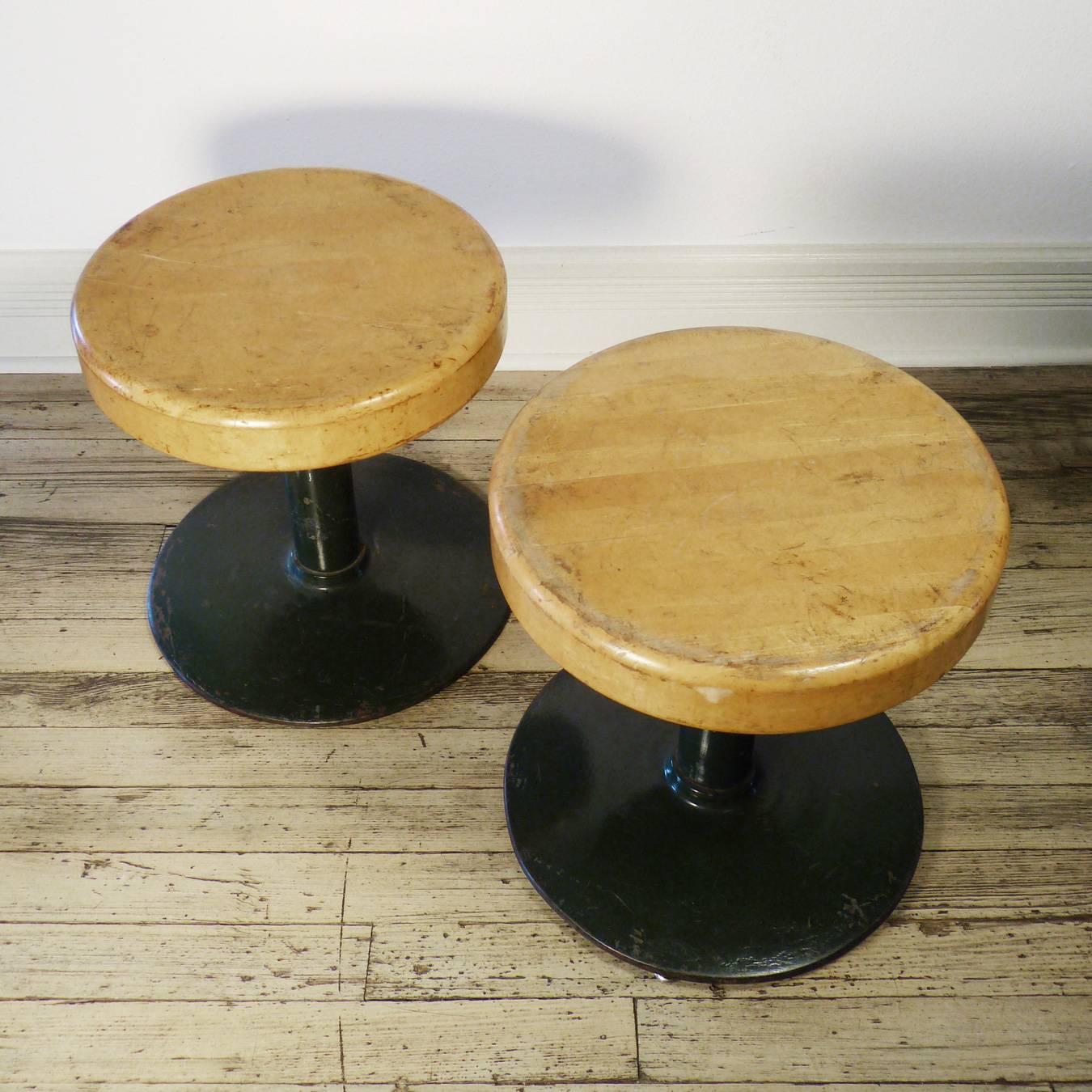 Pair of low profile wood and iron American seats with an industrial feel. 
18" high x 17" wide.