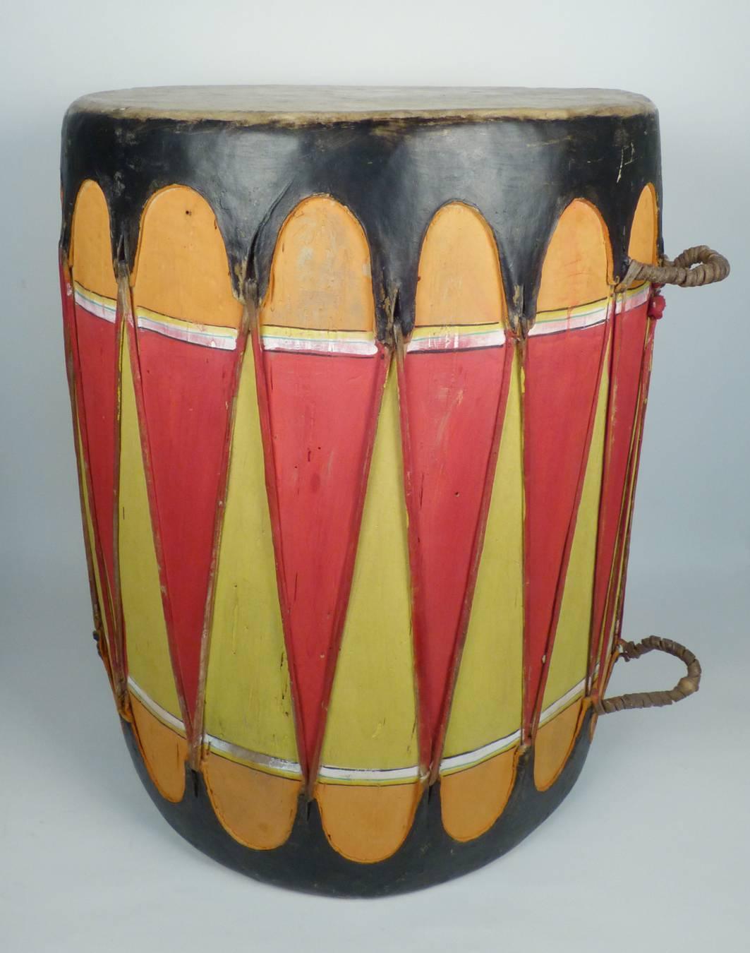 This hand-painted vintage drum was most likely made in the 1940s in Cochiti Pueblo and adds a fun splash of color to any room. Solid wood body and stretched hide drum head. Measures: 17 3/4" x 13".