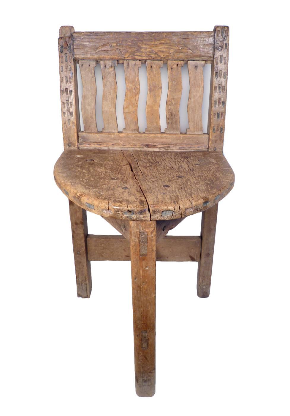 An unusual carved three-legged chair, constructed with mortise and tenon joinery, and decorated with chip carving and bird like designs in the backrest. May have been made in Cochiti Pueblo.
Published in 