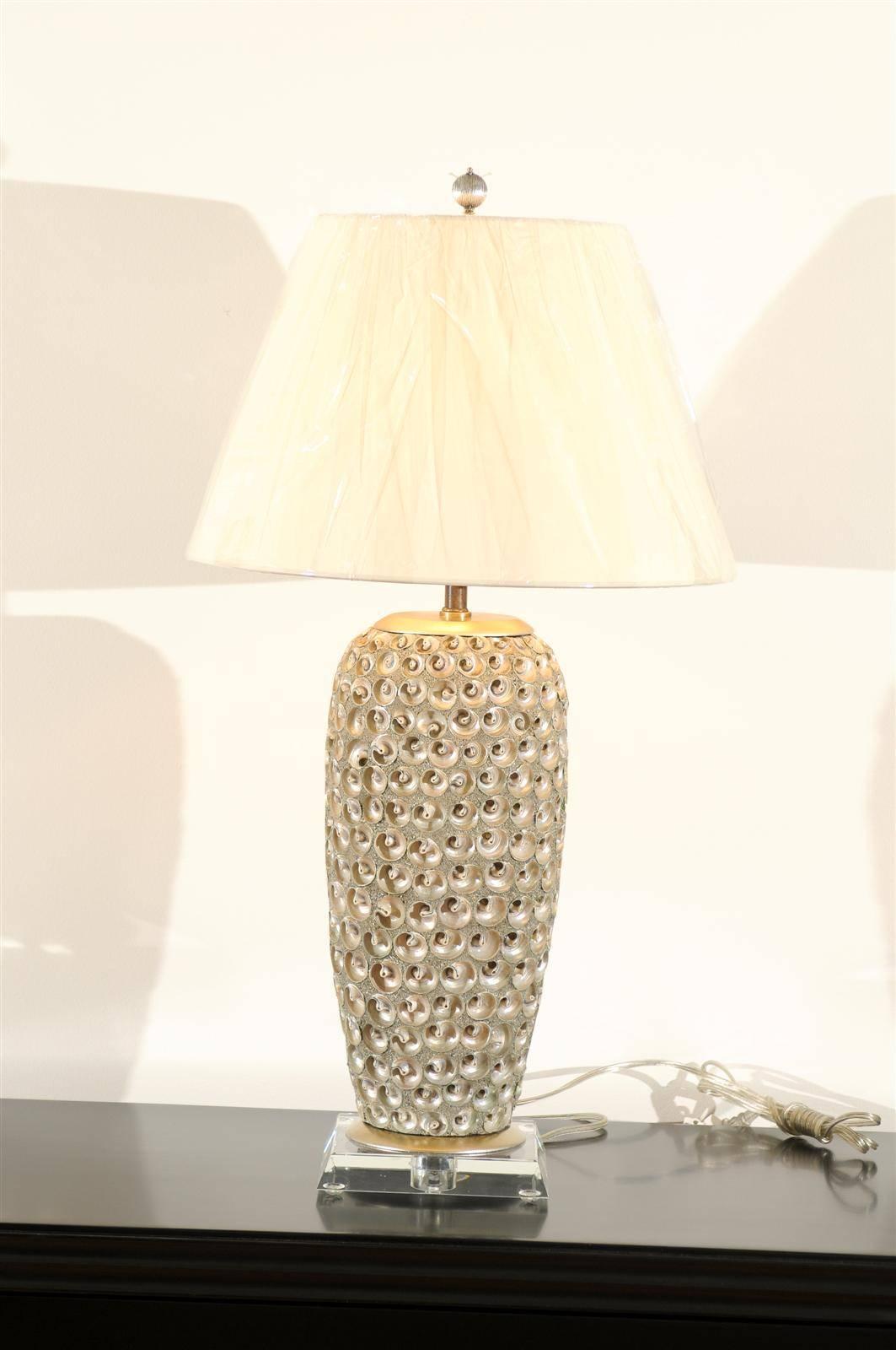 An exquisite pair of shell and aggregate vessels as lamps. Fabulous color, scale and texture. Exceptional jewelry! Excellent restored condition. Wired using clear cord, new distressed brass three-way socket with brass turn switch. New thick Lucite