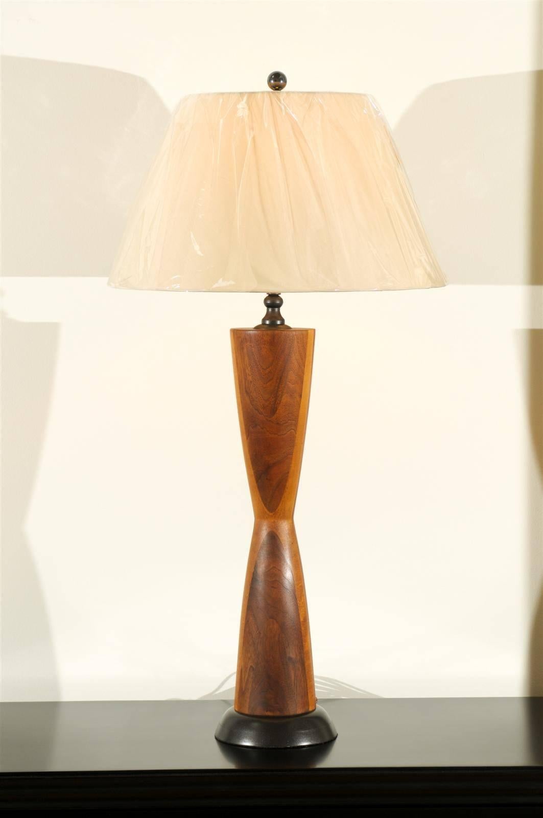 An exceptional pair of vintage hand made Walnut lamps, circa 1950's.  Hourglass shape with beautiful scale and detail. The color and movement evident in the Walnut is absolutely stunning.  Simply Breathtaking !  While the pieces are unmarked, they