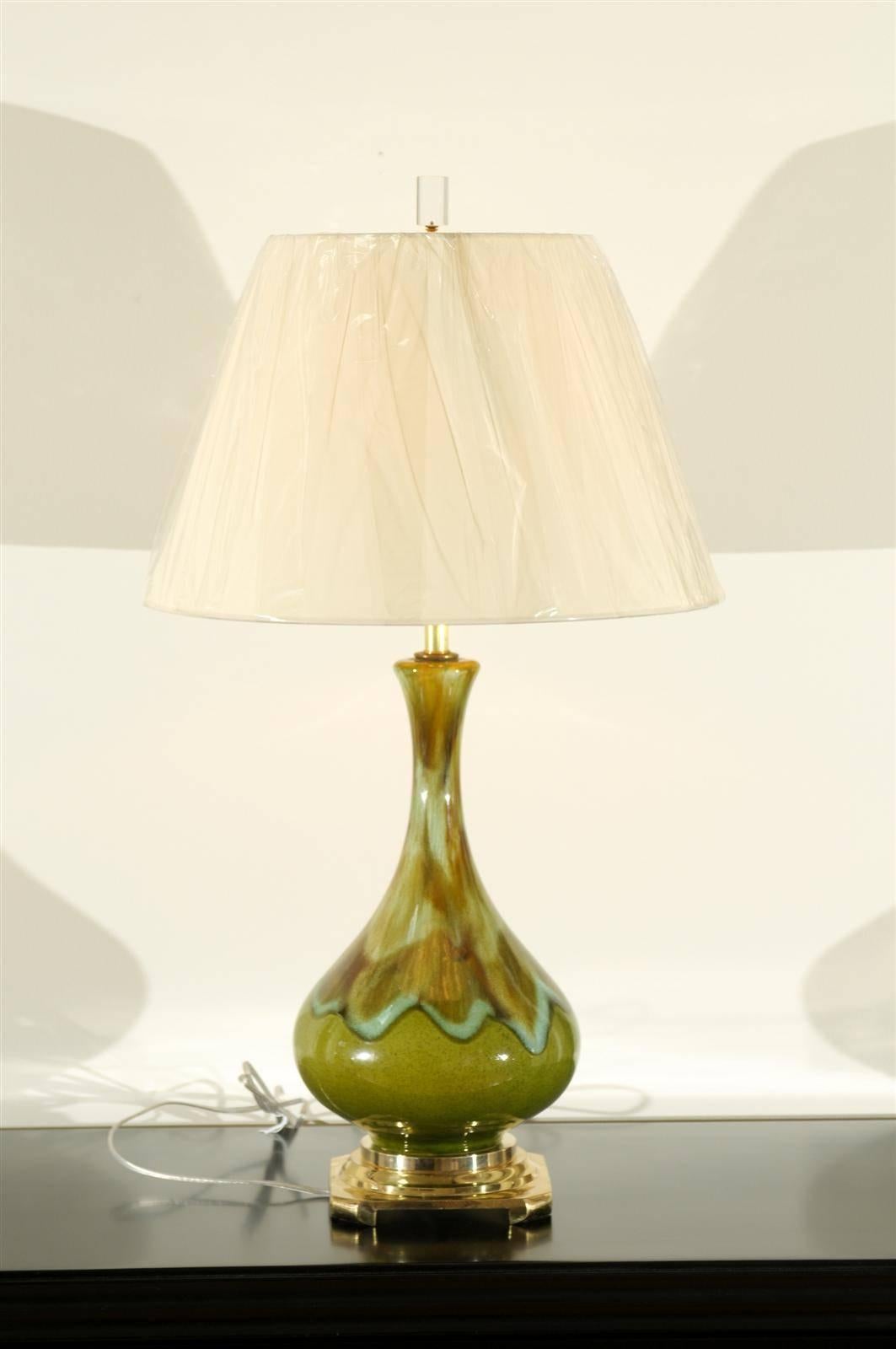 A fabulous pair of vintage ceramic lamps, circa 1970. Drip style executed in an exquisite color composition of apple green, Robins egg blue and caramel. Solid brass two step base. Stunning jewelry! Excellent restored condition. The lamps have been