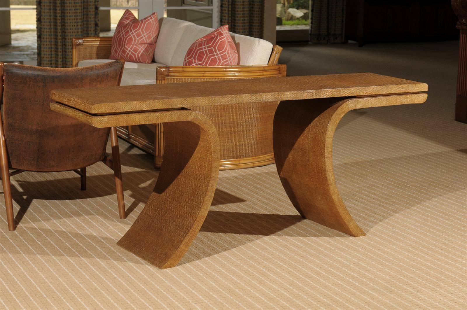 A beautiful and dramatic large-scale vintage console. Gorgeous hardwood Silhouette wrapped in natural raffia veneer. Fabulous color and texture. A heavy, finely crafted focal piece. While the table is unmarked, it is consistent with the Harrison-Van
