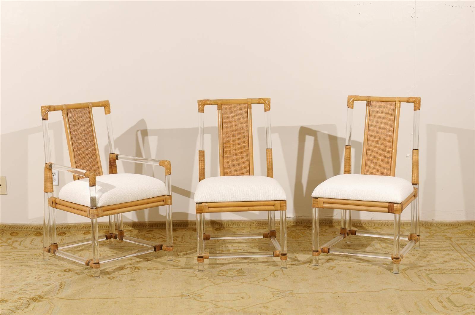 An exceptional set of vintage dining chairs, circa 1975. Lucite rod and hardwood construction with beautiful raffia and rattan accents. Stout, comfortable and expertly made. Fabulous jewelry! Excellent restored condition. The pieces have been