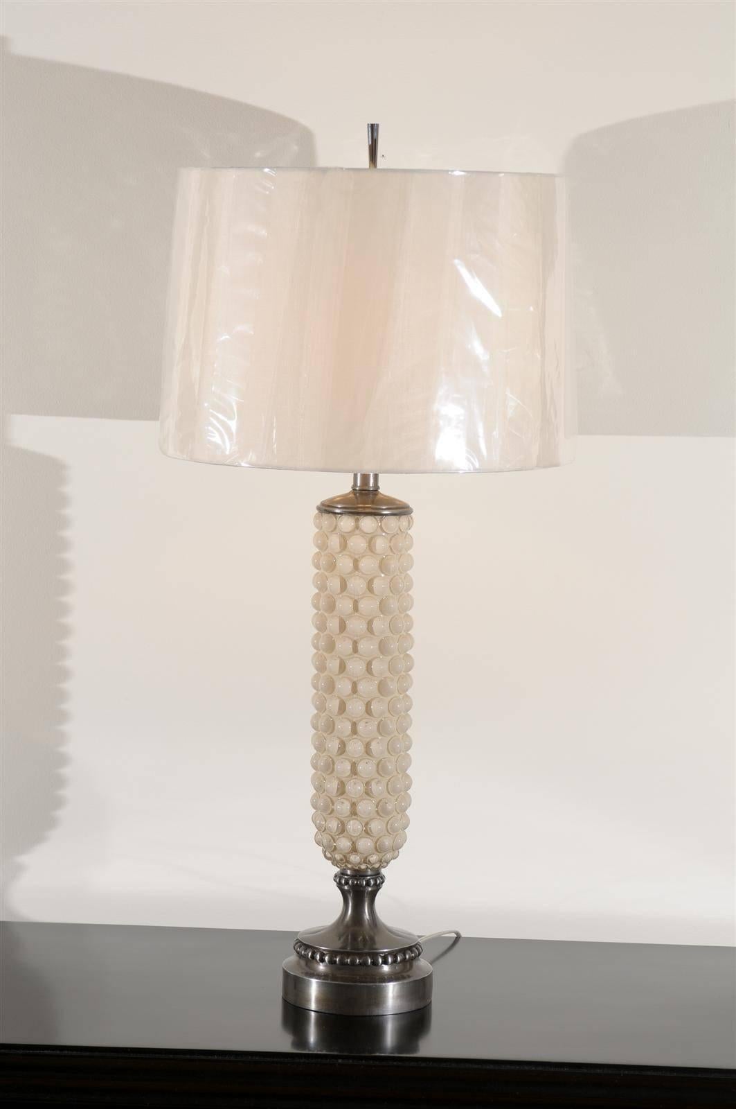 Stellar surviving examples from an unusual lighting line designed by Helena Tynell for the Swedish firm Flygsfors, circa 1960. Thick glass vessels with the iconic bubble pattern, reverse painted in cream. Pedestal base (with bubble detail) and