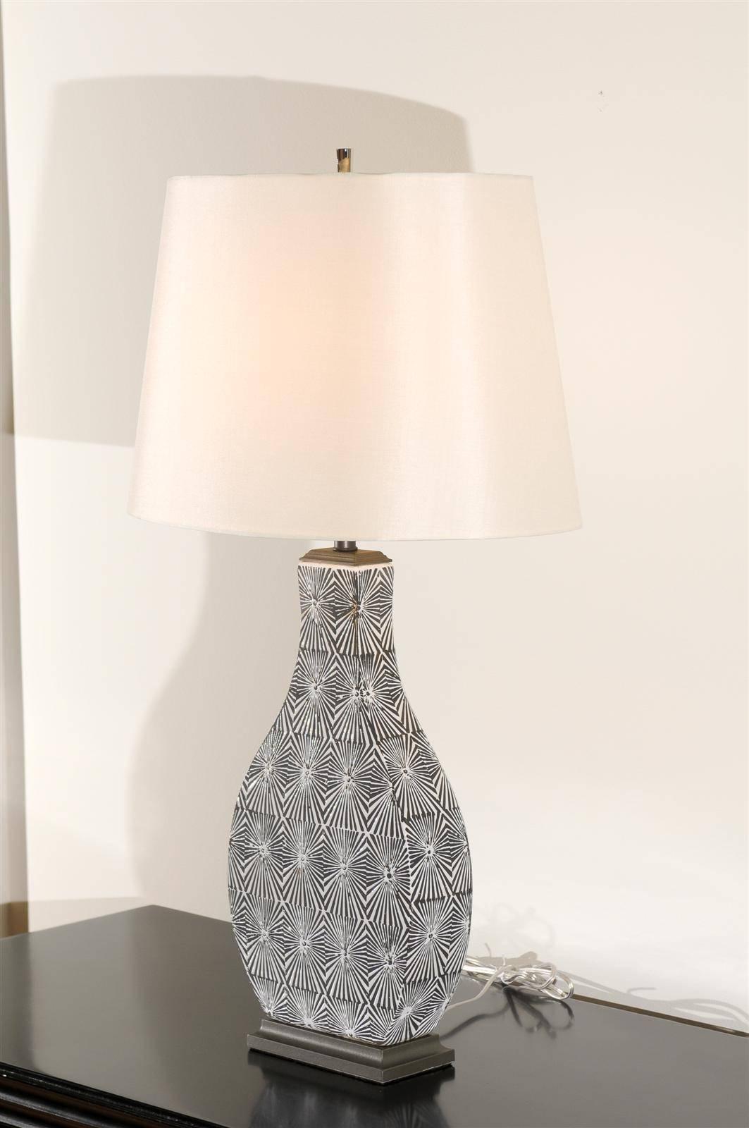 A wonderfully graphic pair of modern lamps, circa 1980s. Sexy ceramic form with glazed sunburst motifs in charcoal and cream. Fabulous design and detail. Dramatic jewelry! Excellent restored condition. Rewired using clear cord, new nickel three-way