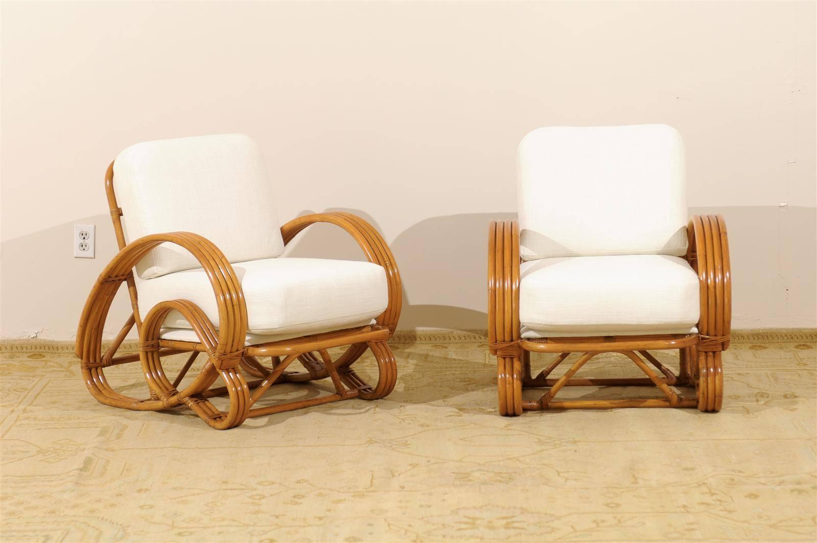 An exceptional pair of vintage four band rattan lounge chairs, circa 1940. The skill and craftsmanship required to produce this highly decorative curvilinear design is significantly more than that of the standard 