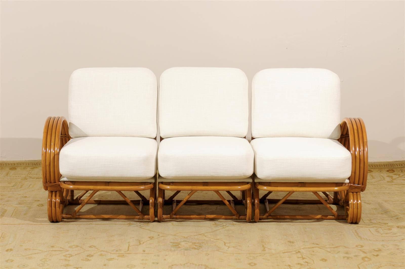 An exceptional, highly unusual vintage rattan four (4) band sofa, circa 1940. The skill and craftsmanship required to produce this curvilinear design is significantly greater than that of the typical 