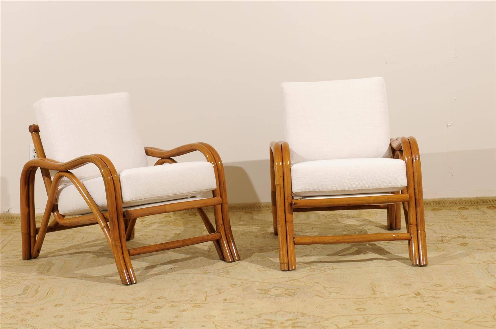 An exceptional pair of vintage modern loungers, circa 1950. Stout, expertly made rattan frame construction. Beautiful design and detail. Room defining statement pieces. The matching three (3) seat sofa is available in a separate listing, making a