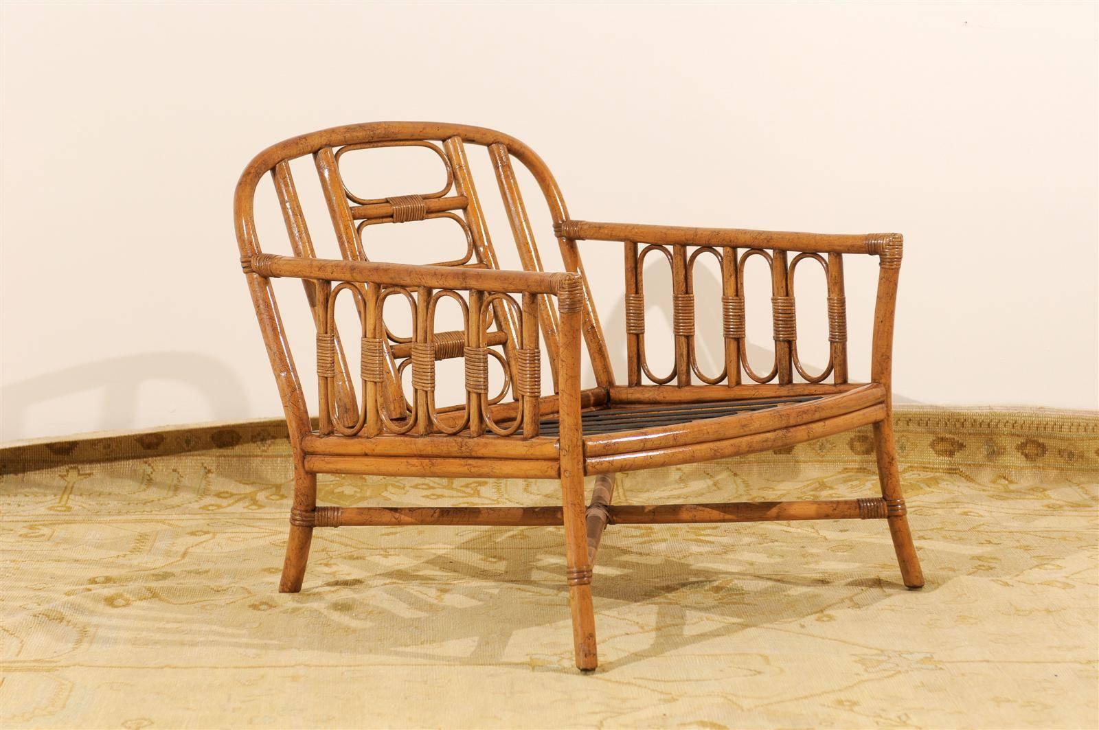 A wonderful pair of highly decorative rattan lounge chairs by Ficks Reed, circa 1970s. Beautifully proportioned with fabulous detail. Excellent restored condition. The chairs have been professionally cleaned and re-lacquered. The rattan displays
