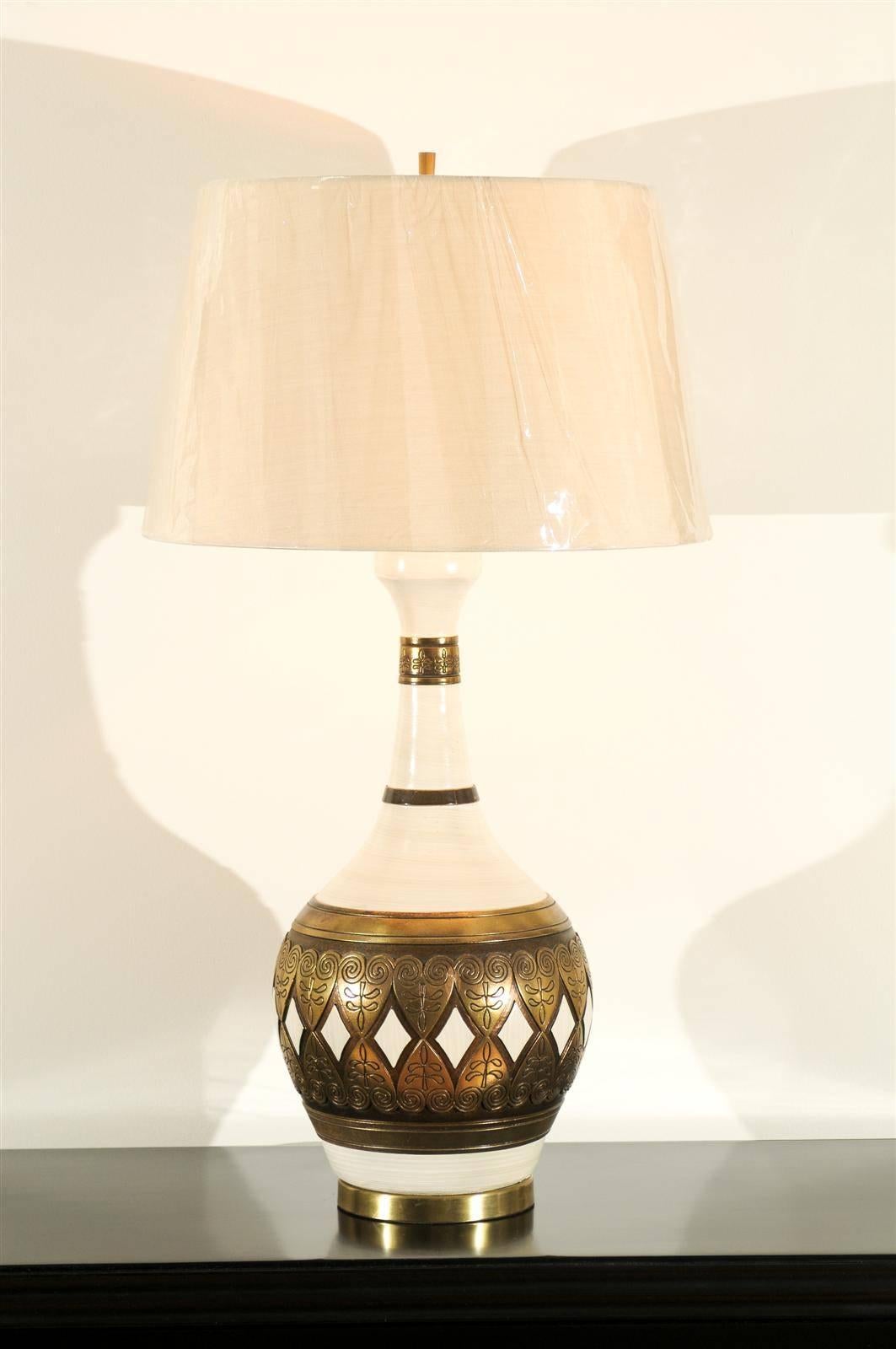 A spectacular pair of large-scale vintage lamps by Fortune Lamp Company, circa 1961. Cream ceramic vessels with fabulous gold detail which portrays the look of genuine forged brass. Remarkable design and craftsmanship. This small boutique lighting