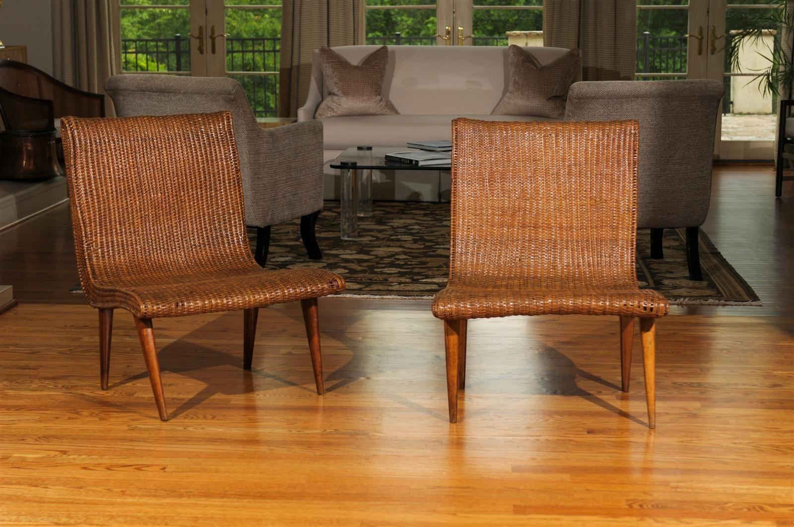 A beautiful and unusual pair of vintage slipper loungers, circa 1945. Expertly crafted mahogany frame covered in wicker. Exquisite pieces mellowed to absolute perfection. Fabulous! Excellent restored condition. The chairs have been professionally