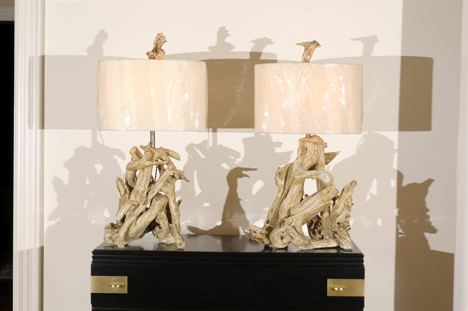 A fabulous pair of vintage driftwood lamps (West Coast USA, circa 1950). Beautiful aged Gesso finish with subtle moss and grey highlights. Wonderful scale and patina. Exquisitely made pieces. Organic sculpture as lighting. Excellent restored
