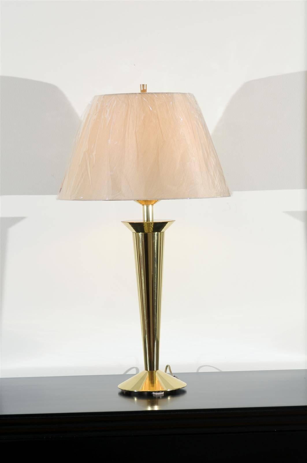 A stunning pair of vintage modern lamps, circa 1980. An updated interpretation of a Classic Art Deco lighting form. Solid brass casing over a cast metal structure. Heavy, beautifully made pieces. Exquisite jewelry! Excellent Restored Condition.