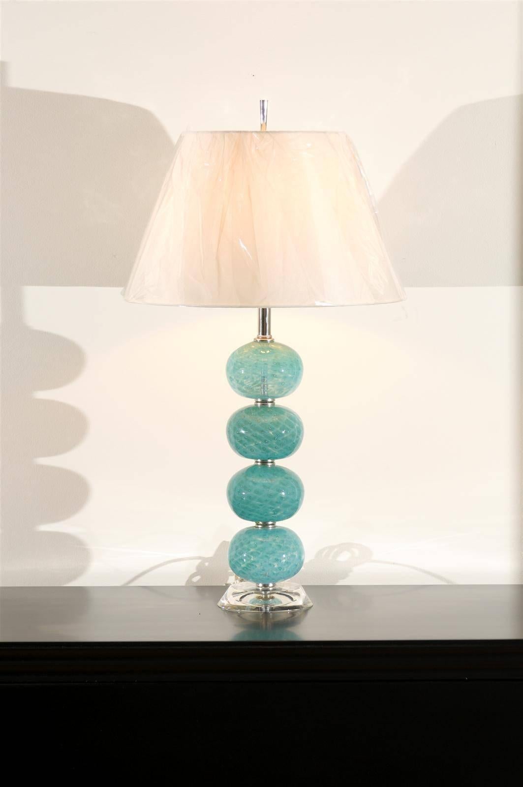 A stunning pair of vintage Murano lamps, circa 1970. Comprised of a series of blown glass balls, fabulous color and pattern introduced via reverse paint. Atop the original thick Lucite disk base. Exquisite jewelry! Excellent restored condition.
