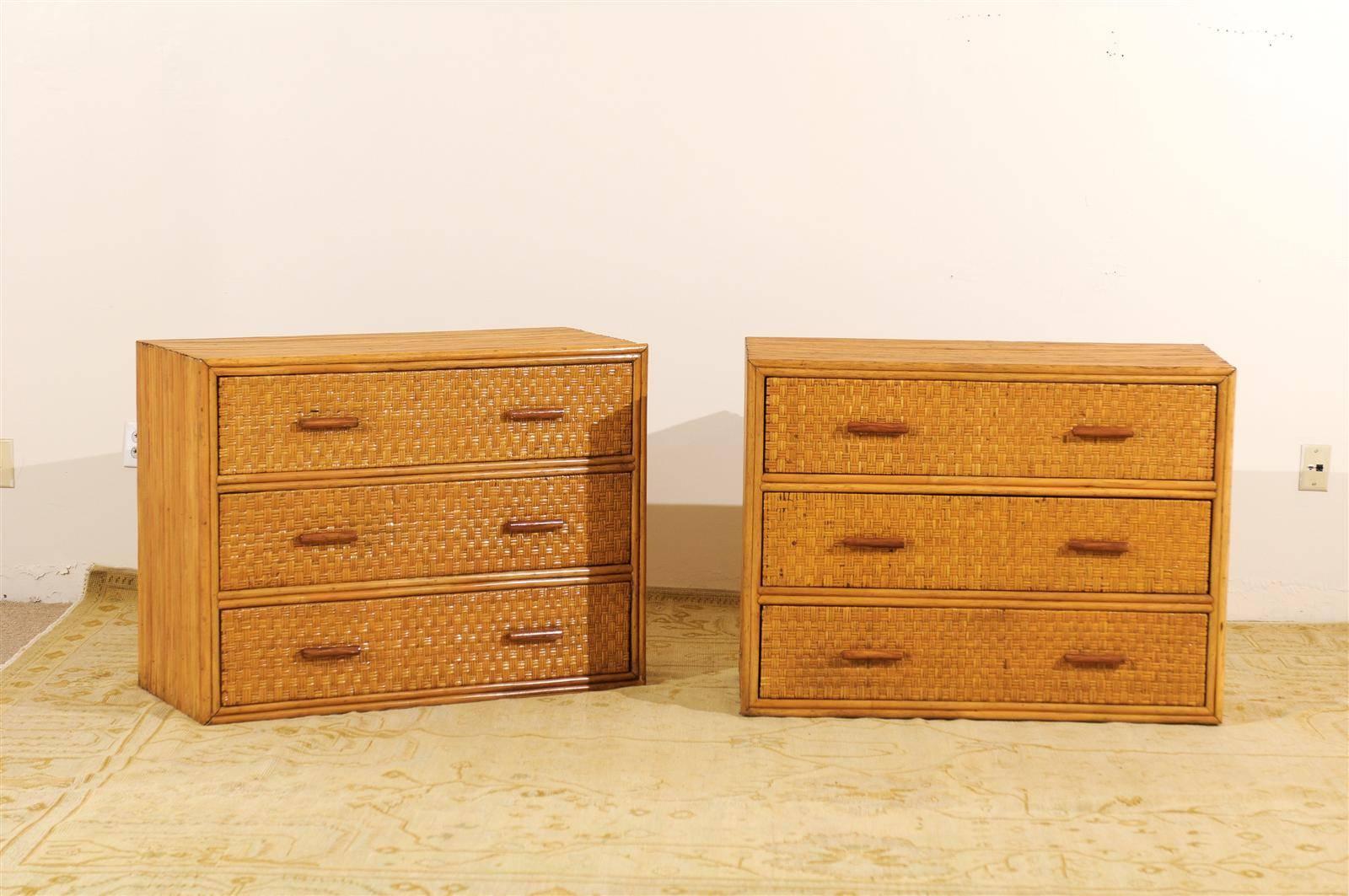 A lovely pair of vintage chests, circa 1950. Expertly crafted mahogany case construction, veneered in individual pieces of bamboo. Drawer fronts are covered in a rattan basket weave raffia. Beautiful detail and workmanship- aged to absolute