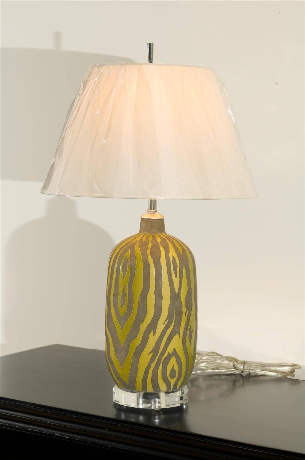 A fabulous pair of vintage ceramic lamps. Crisp zebra print executed in a citrus glaze. Beautiful weight and craftsmanship. While the lamps are unmarked, they are consistent with Italian ceramic production of the early 1970s. Stylish jewelry!