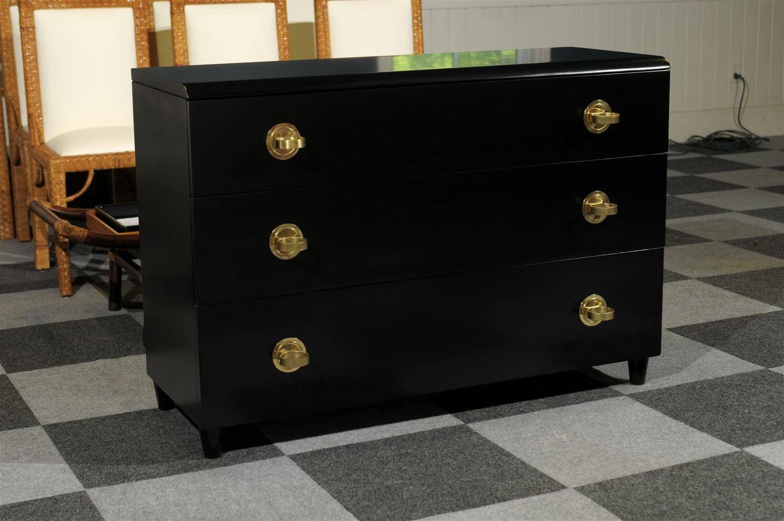 An absolutely stunning modern three-drawer commode by John Stuart, circa 1940. Clean, elegant mahogany case design with a striking bullnose detail along the front of the top. Chunky solid brass hardware accent the drawers. An exceptionally made