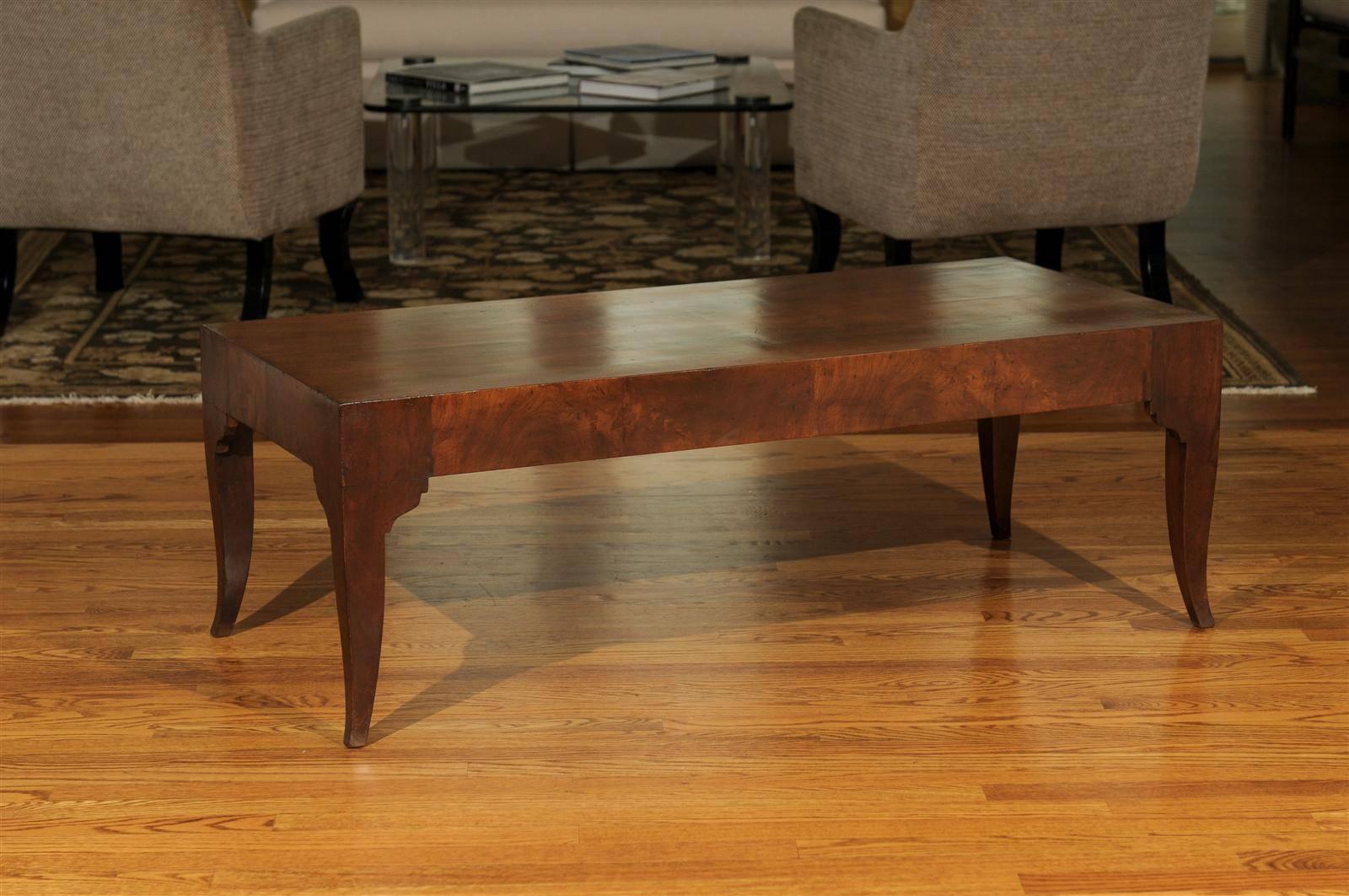 An outstanding vintage coffee table, circa 1960. Beautiful design with a fabulous leg detail, executed in bookmatch walnut veneer. Exceptional quality and craftsmanship. Exquisite jewelry! Excellent restored condition. The table has been