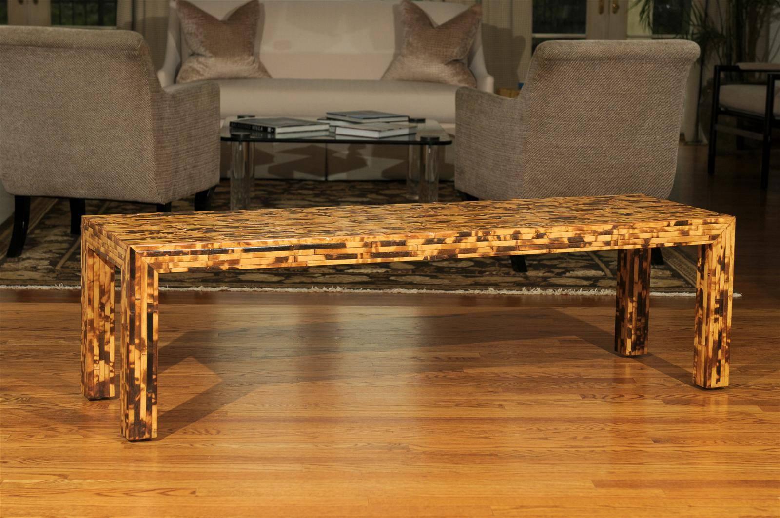 An outstanding custom-made vintage coffee table or bench, circa 1970. Stout hardwood form veneered in pieces of bamboo. Beautiful quality and workmanship. The range of color in the bamboo creates a tortoise shell effect.  Exquisite jewelry!