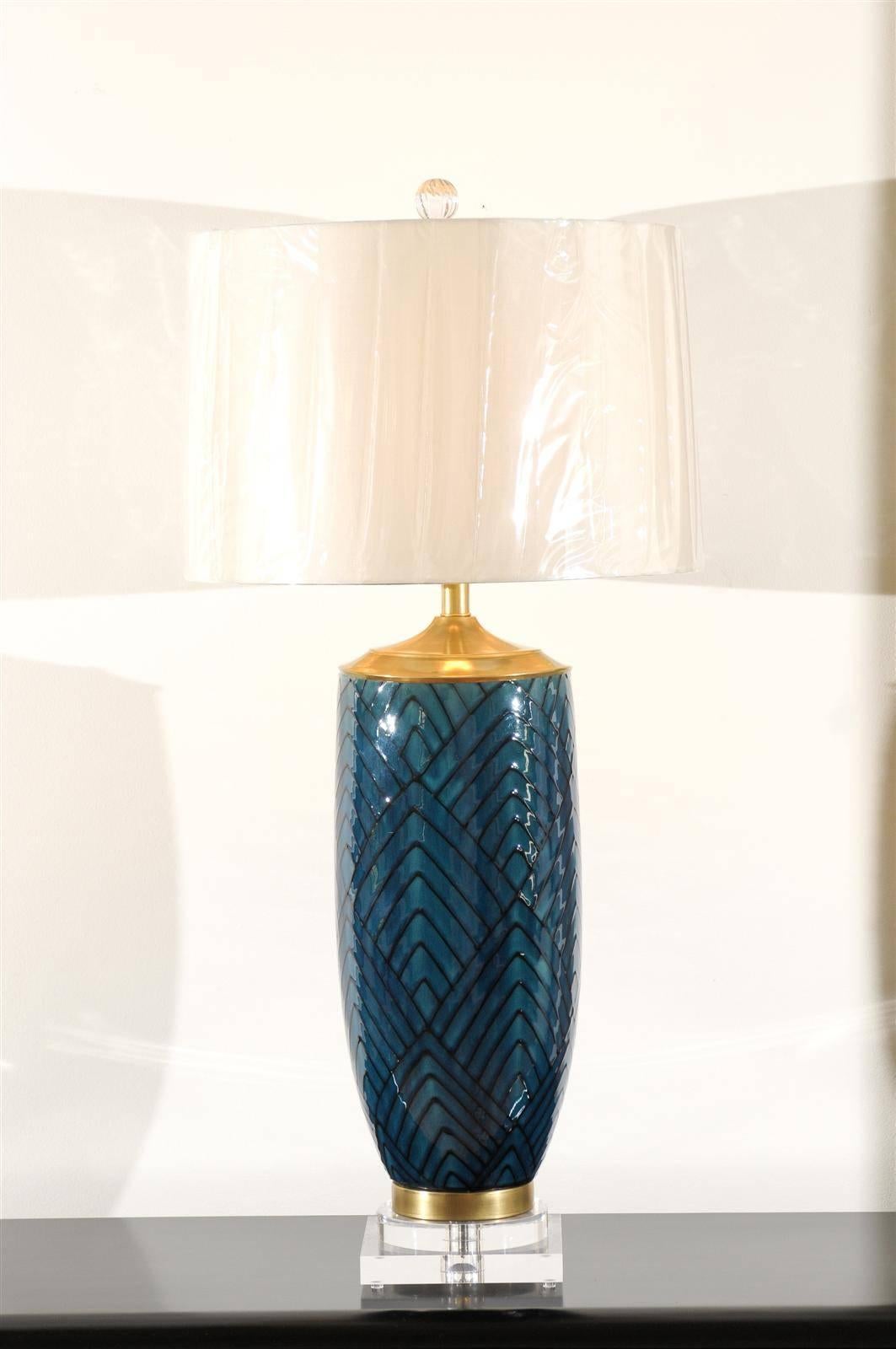 An absolutely stunning pair of large-scale vintage lamps, circa 1970. Handsome ceramic vessels with a lovely geometric motif and accents of solid brass. Mounted on a new two-step base crafted from thick Museum quality Lucite. Heavy, exceptionally