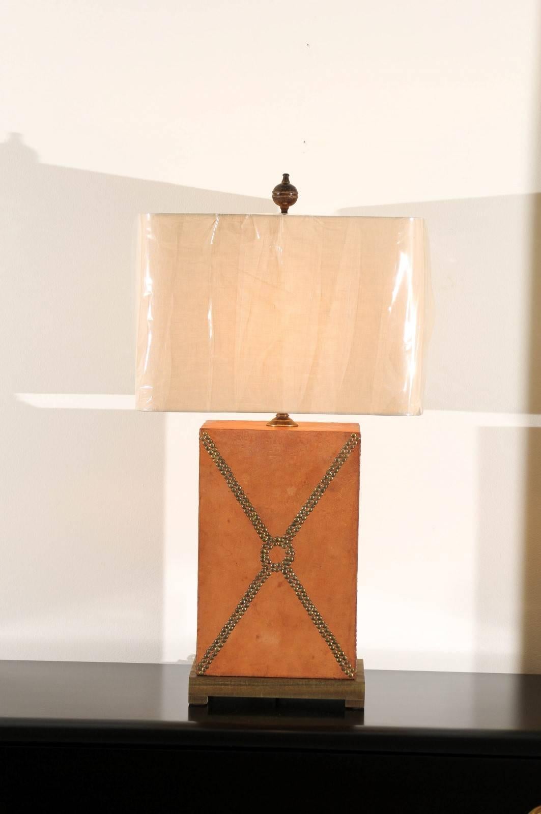 A beautiful pair of custom-made lamps, circa 1970. Hardwood form covered in leather with brass studs as accents. Wonderful color and patina. From the estate of a storied Atlanta designer. Fabulous jewelry! Excellent restored condition. Rewired using