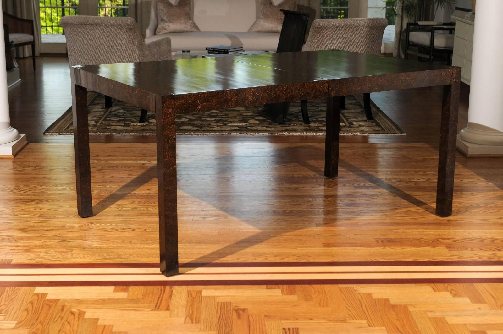 An exceptional vintage Parsons style extension dining table, circa 1970. Stout, expertly made hardwood construction with lovely detail. Slender table depth allows for intimate dining conversation. Lacquered oil drop technique creates the look of